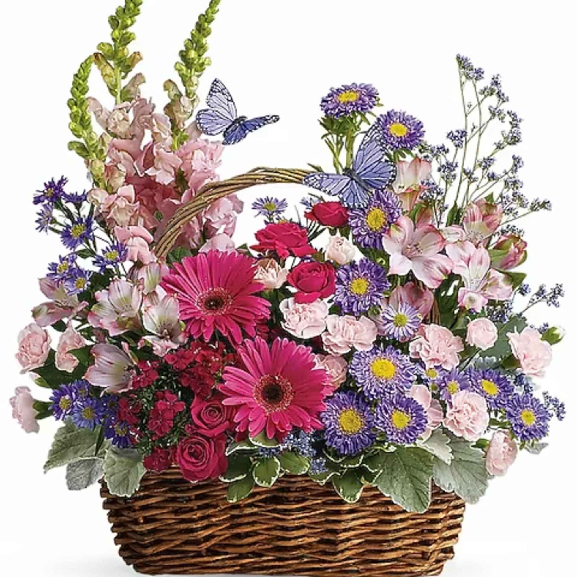 Basket arrangement of pink and purple flowers with a butterfly decoration