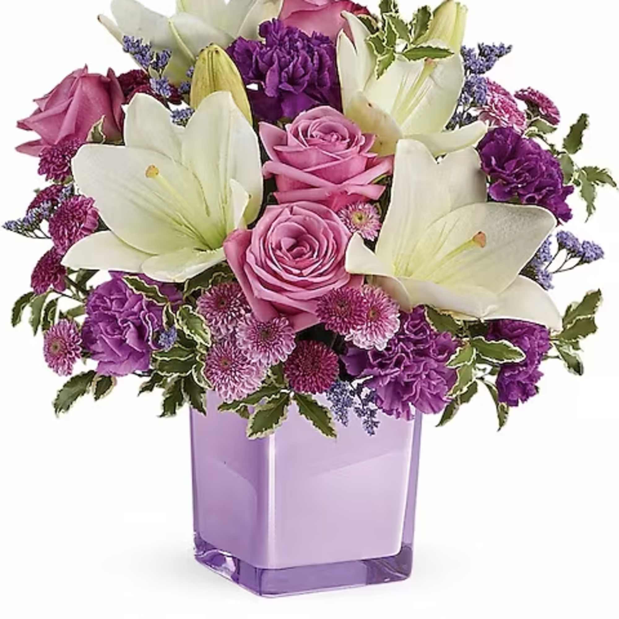 Pink roses and white lilies in a purple glass vase