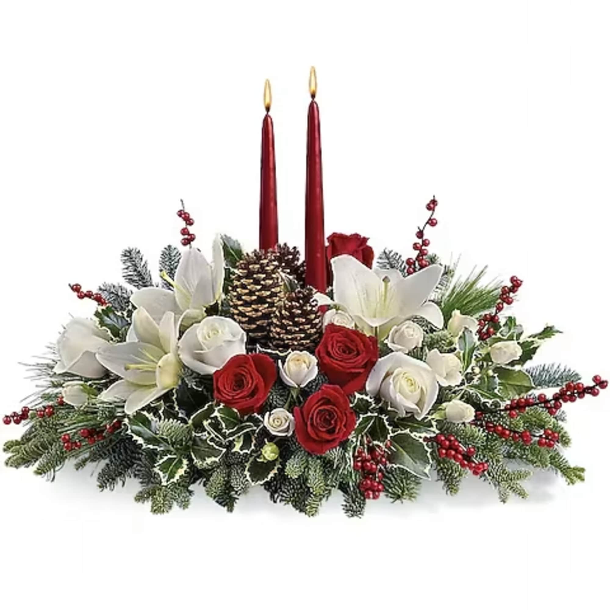 Holiday centerpiece with red candles, white lilies, and red and white roses
