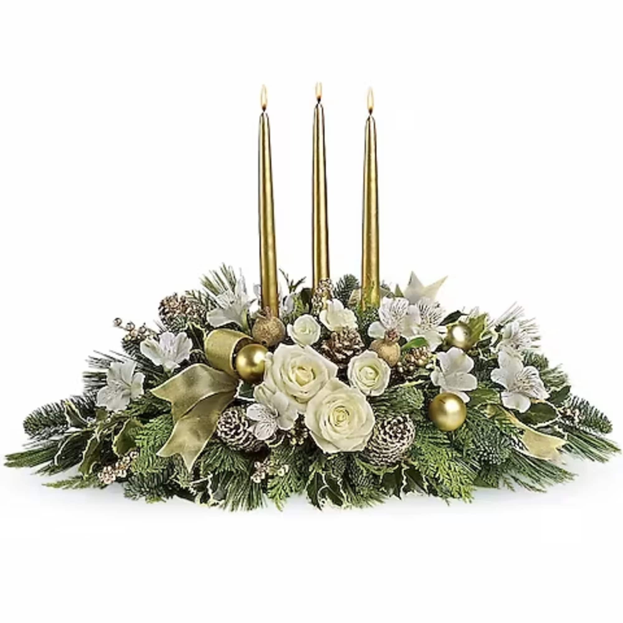 Holiday centerpiece with white roses, gold candles, and evergreen accents