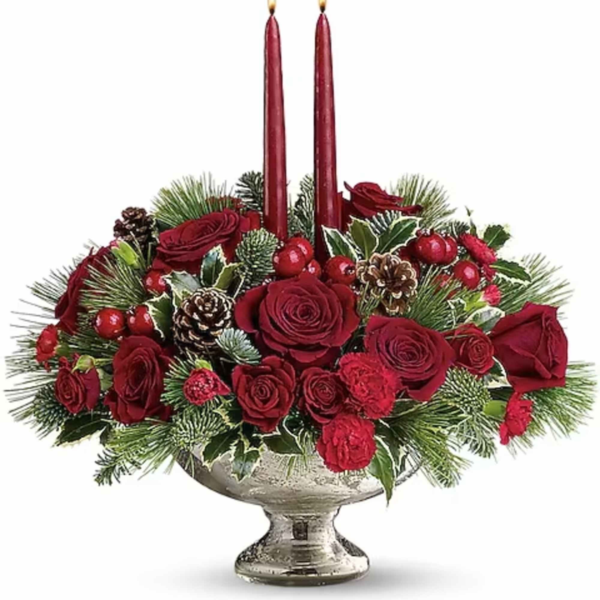 Red rose centerpiece with two burgundy taper candles in a silver pedestal bowl