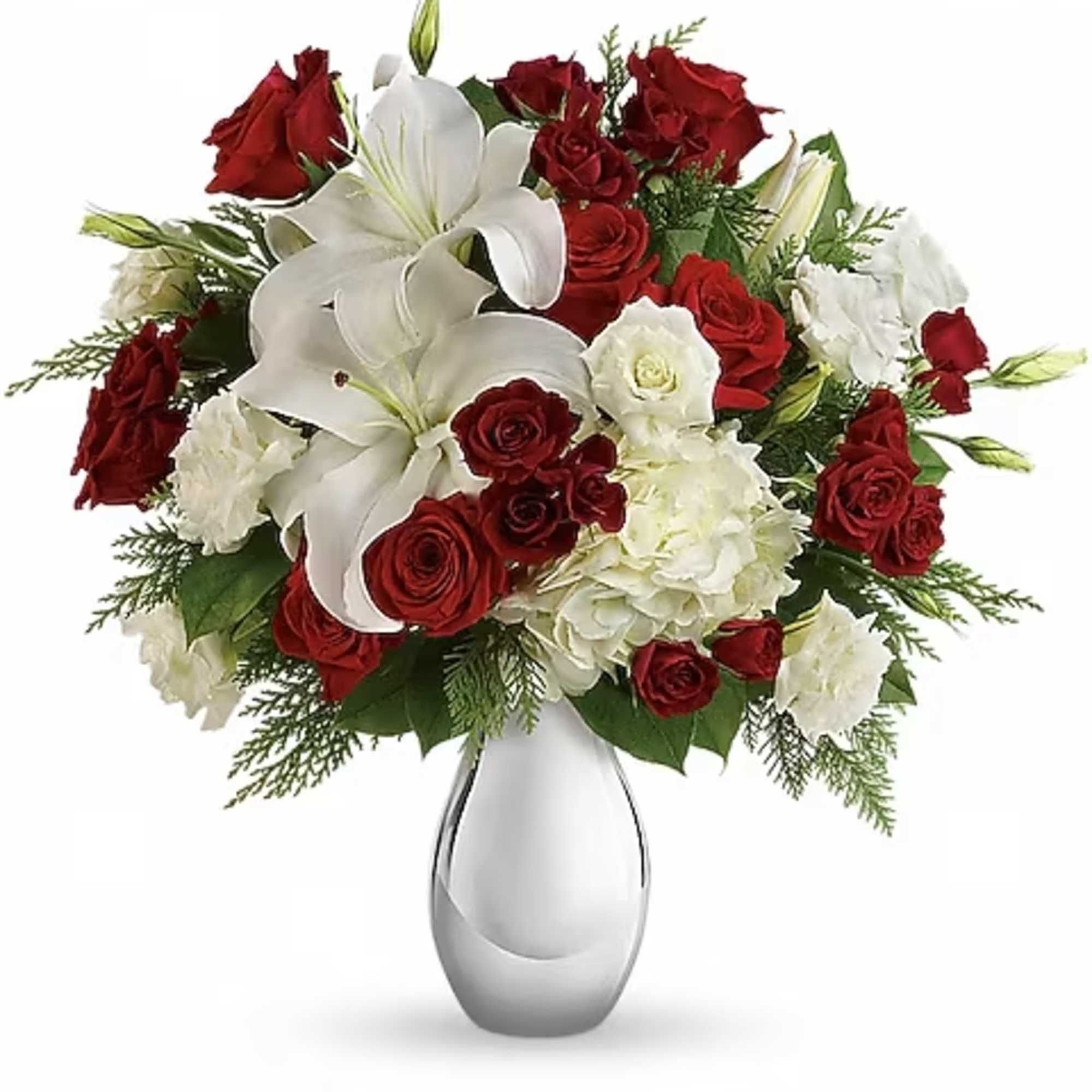 Red roses and white lilies arranged in a clear glass vase