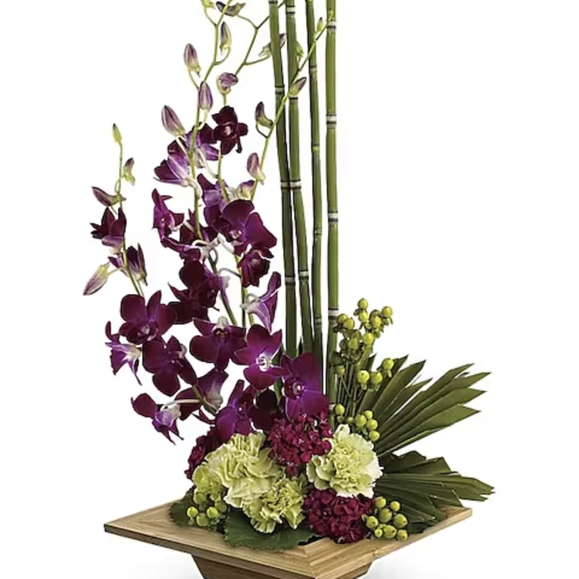 Purple orchids with green carnations in a bamboo container