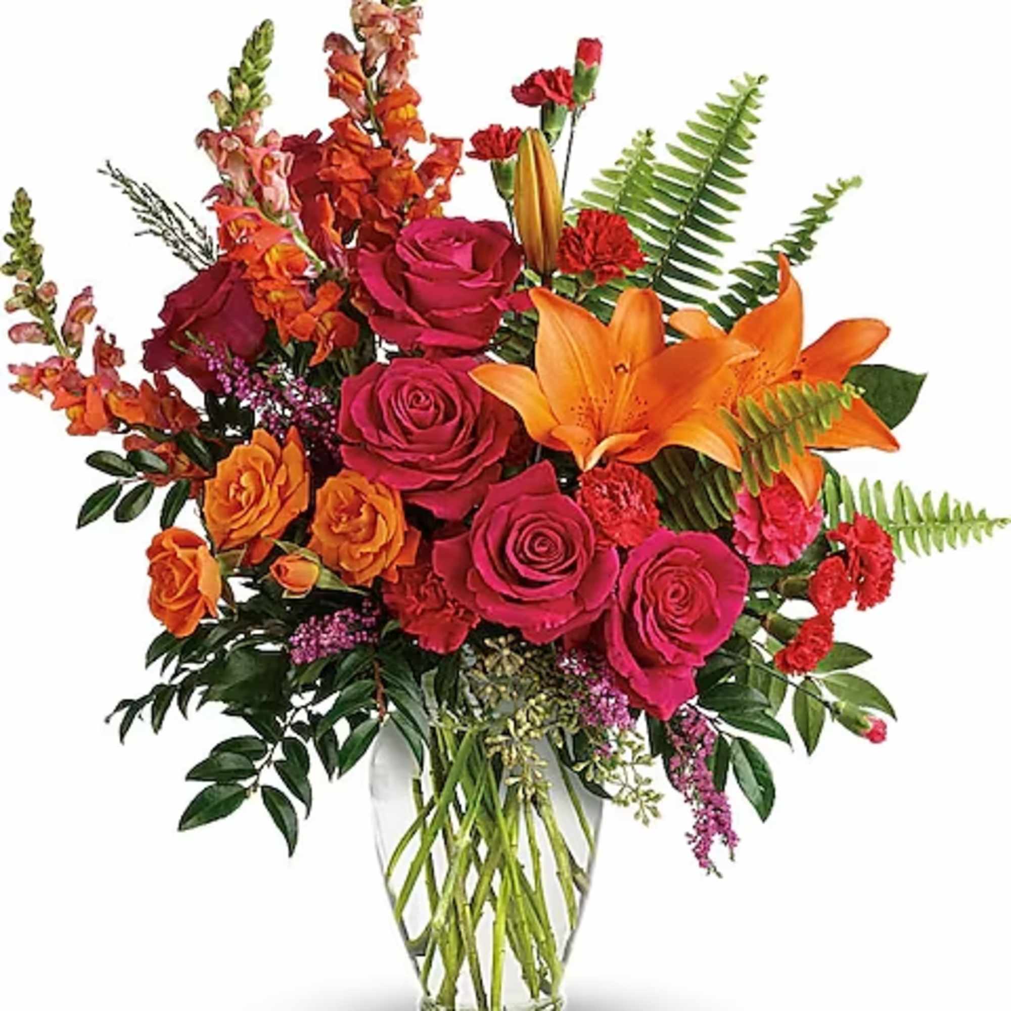 Bright mixed bouquet of roses and lilies in a clear glass vase