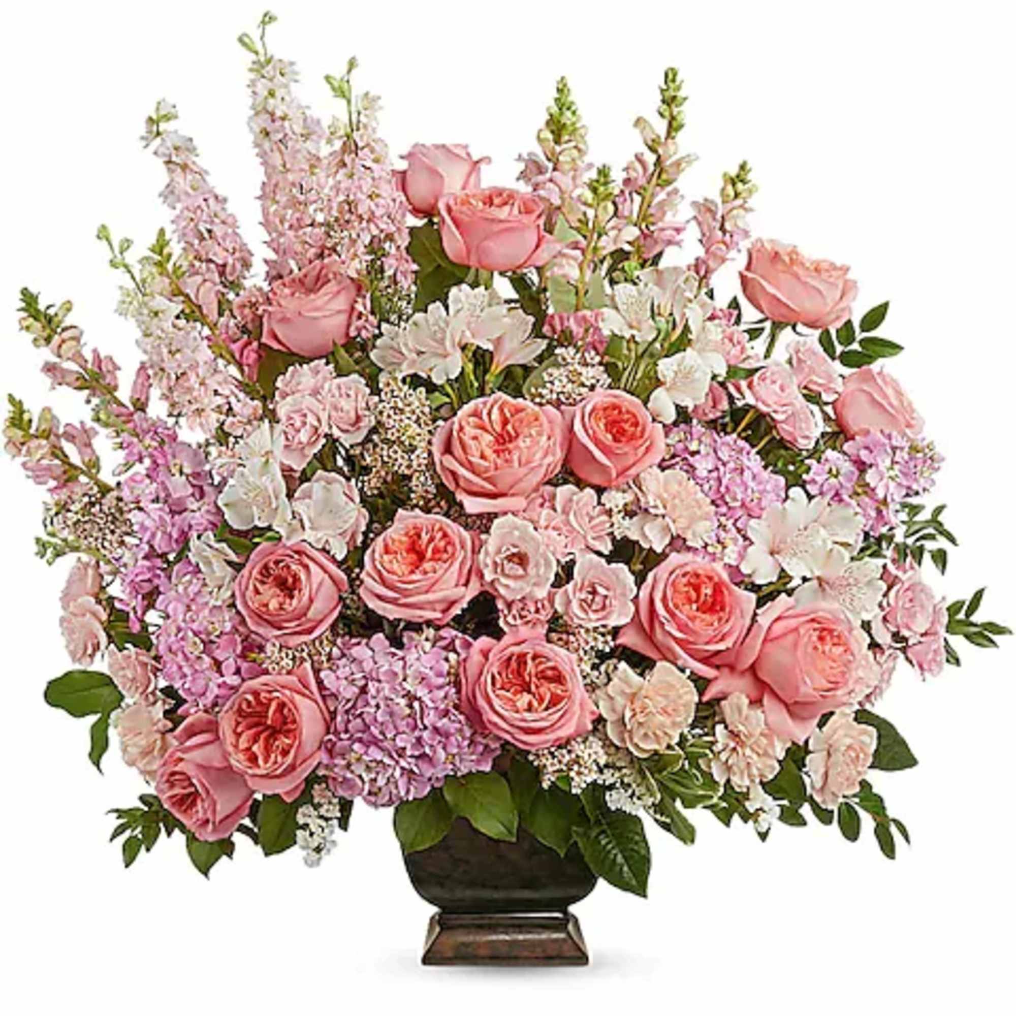 Pink roses and pastel flowers arranged in a dark vase