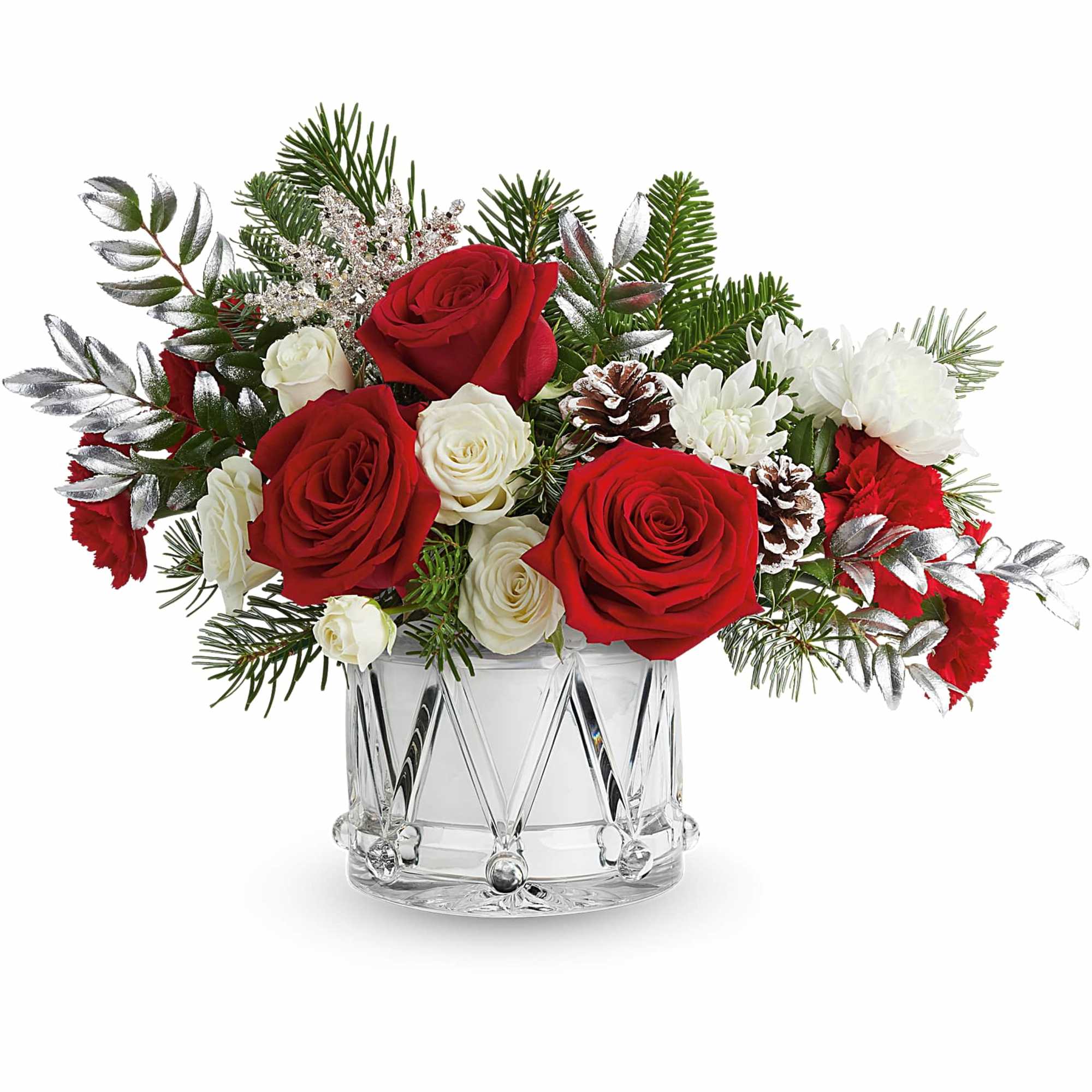 Red and white roses in a clear glass vase with pinecones and evergreen sprigs