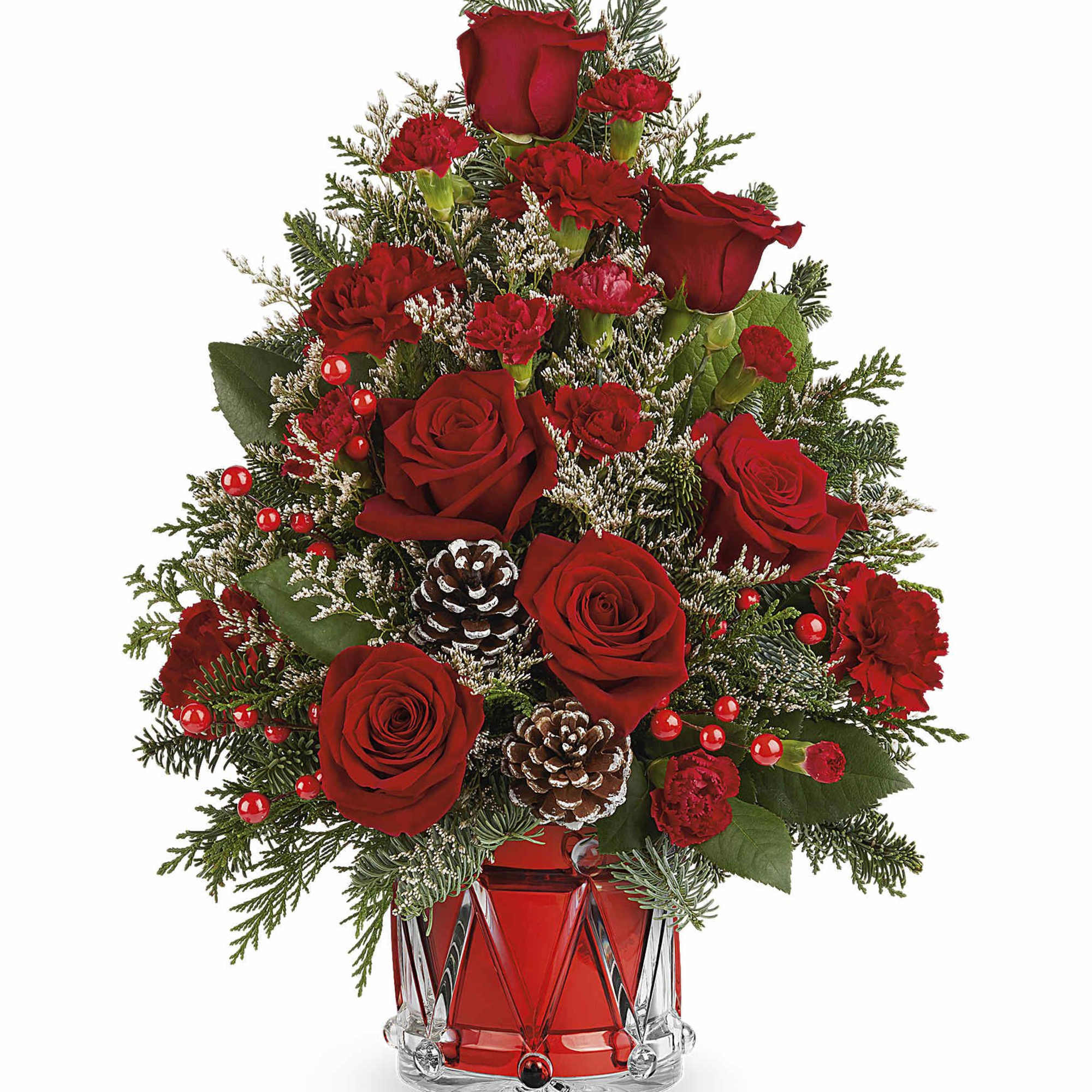 Red roses and carnations arranged in a red glass vase with pinecones.