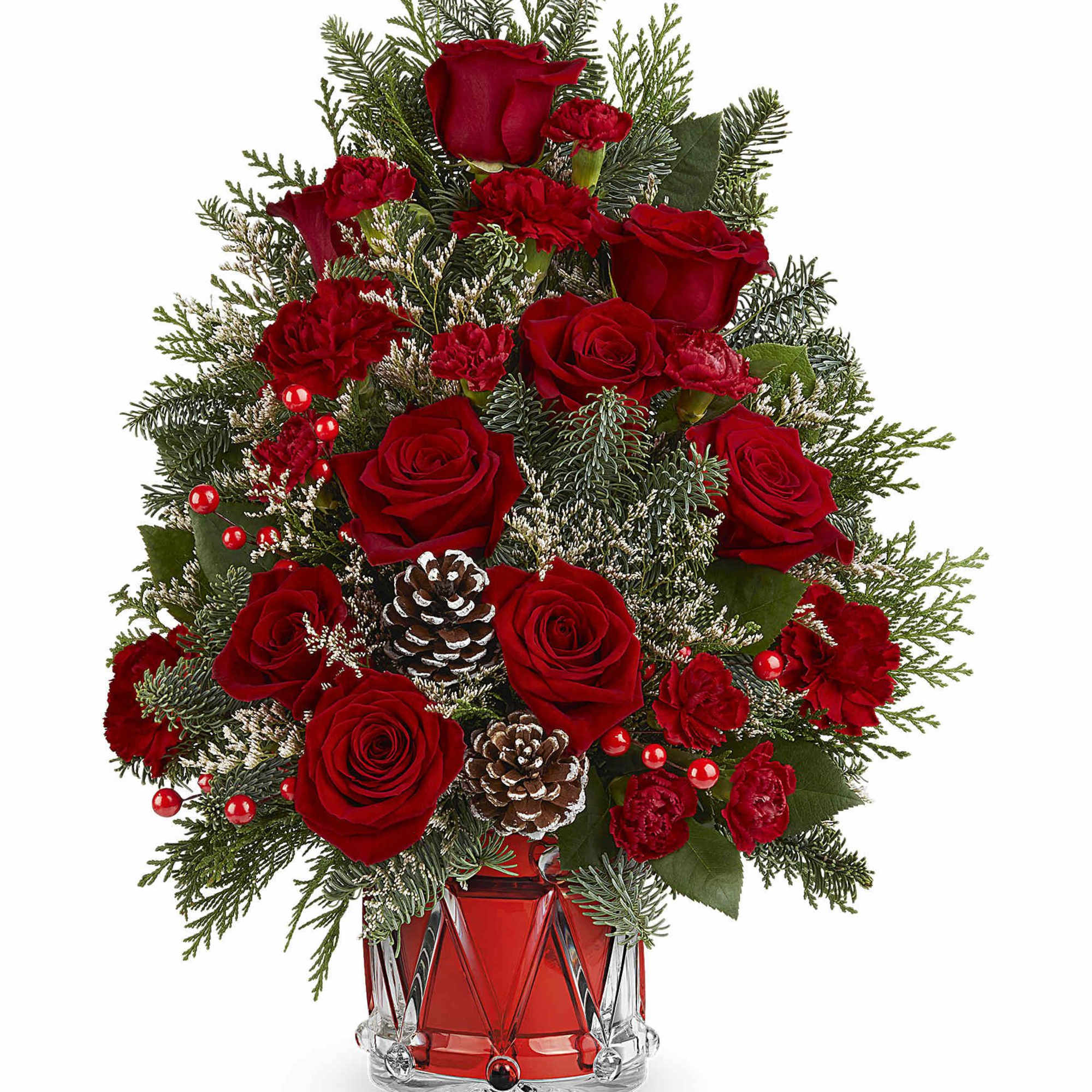 Red roses and carnations in a glass vase with pinecones and evergreen branches