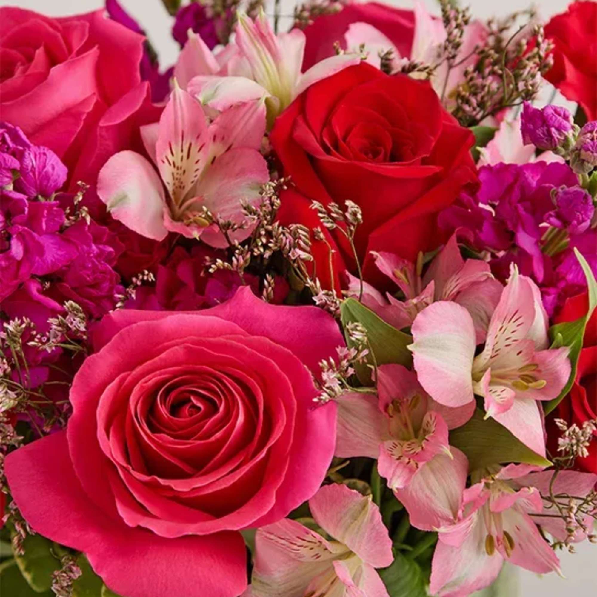 Bouquet of pink and red roses with pale pink lilies