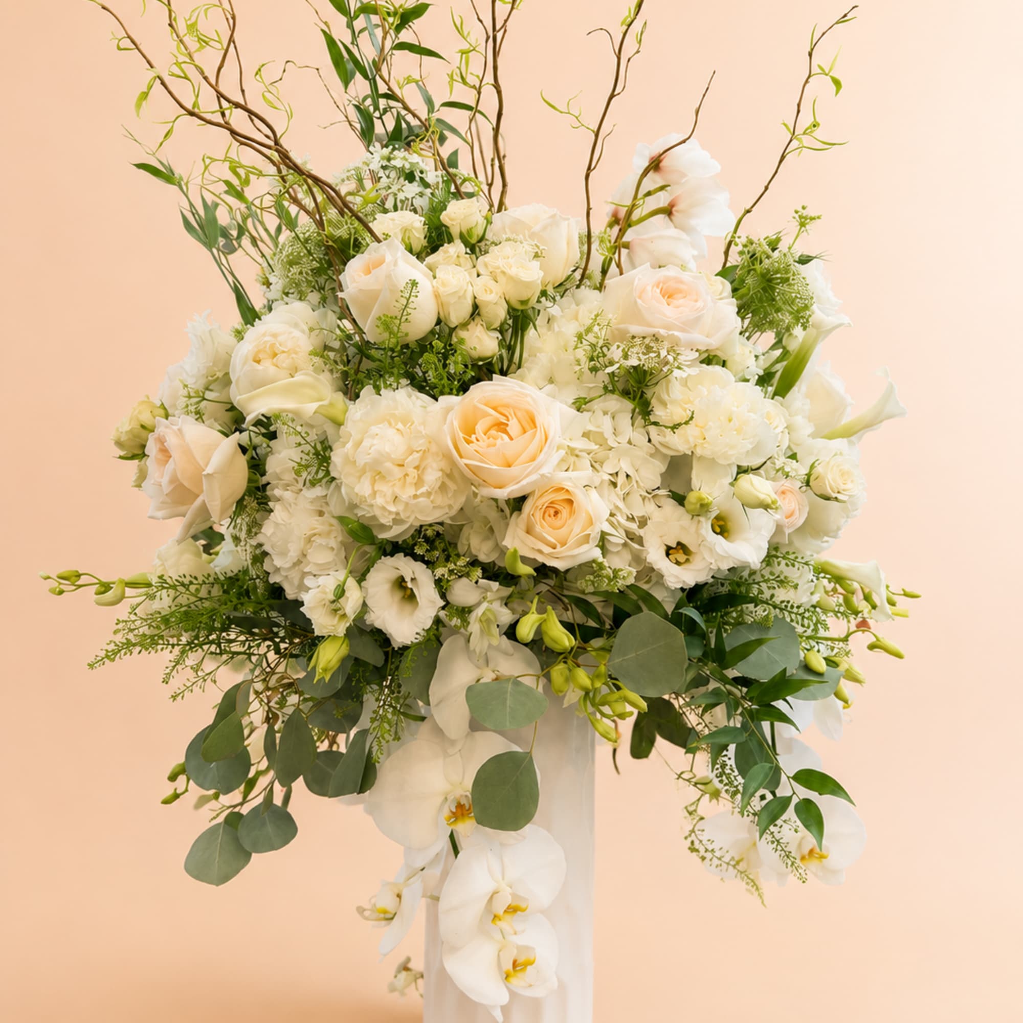 Beautiful one-sided arrangement with a mixture of roses, orchids, hydrangeas, greenery, lisianthus