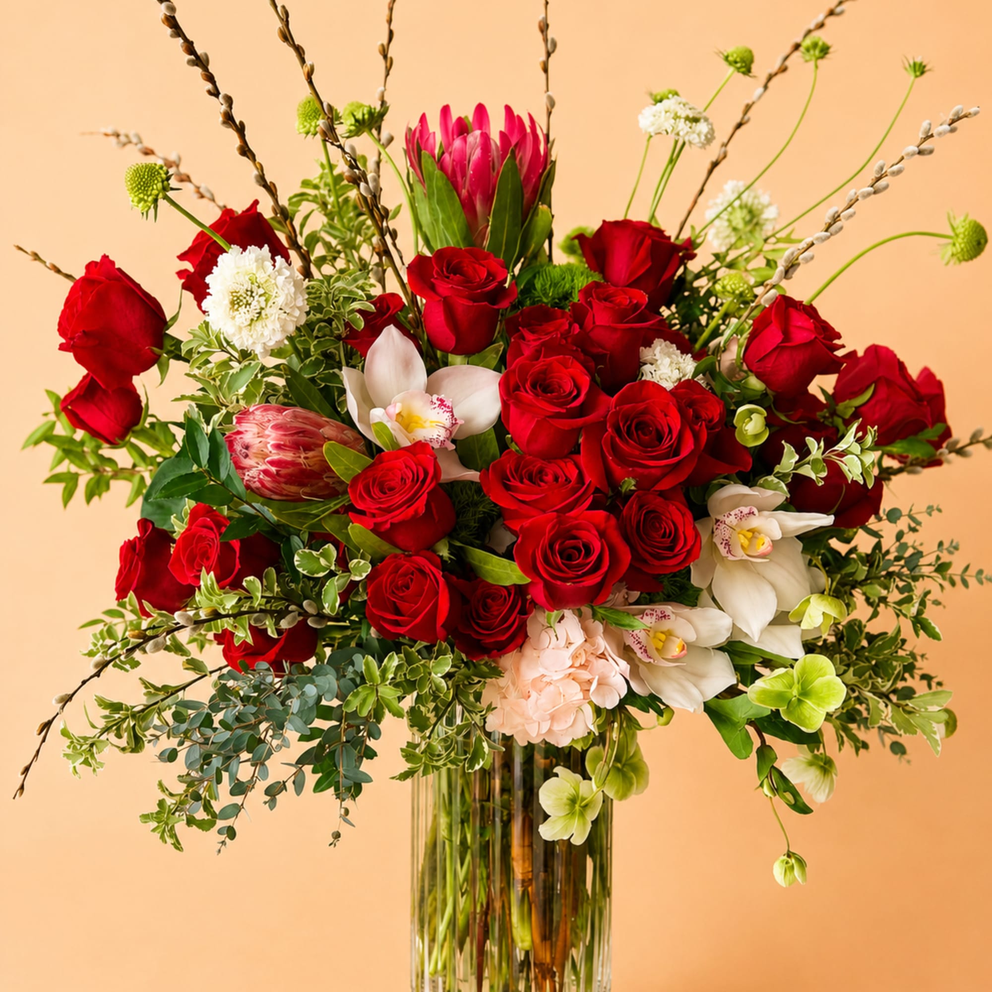 Beautiful one-sided flower arrangement with red mix blooms. This arrangement is built