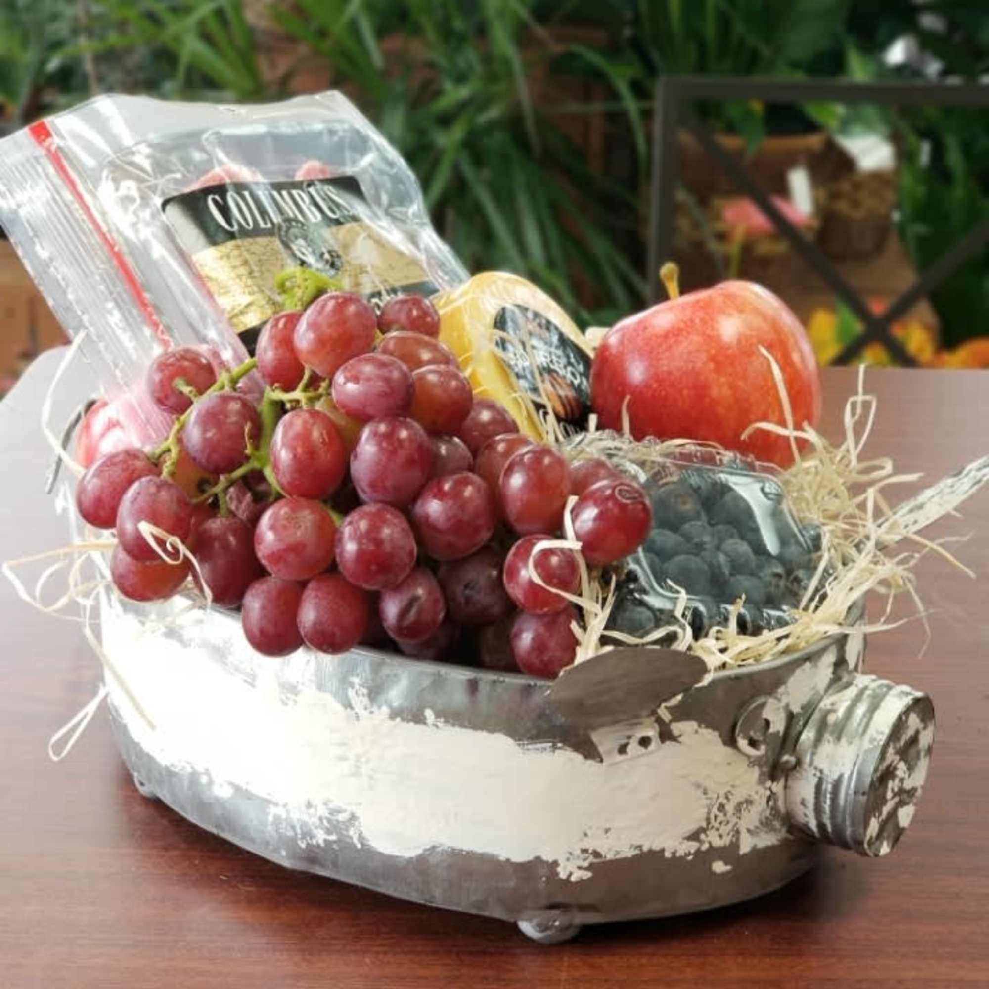 Fruit gift basket in a metal container shaped like a pig