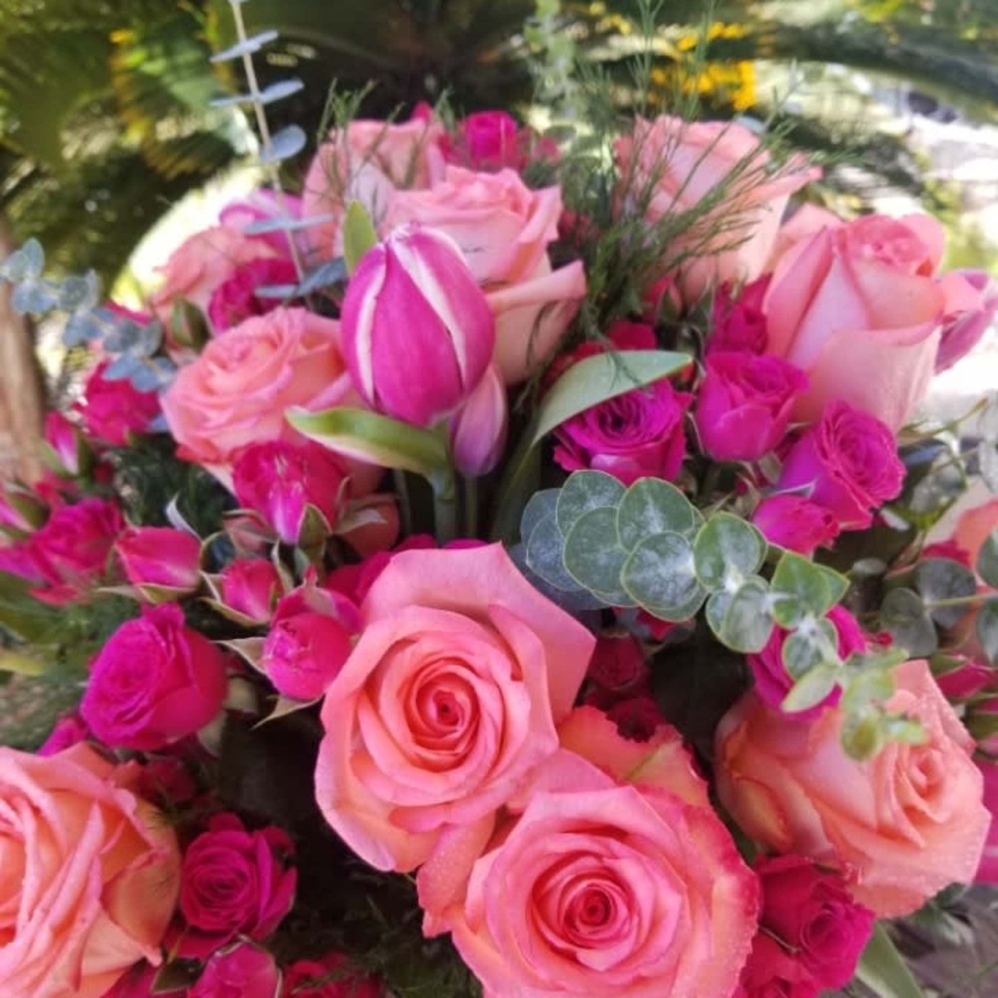 Pink roses and magenta spray roses with a pink tulip bouquet
