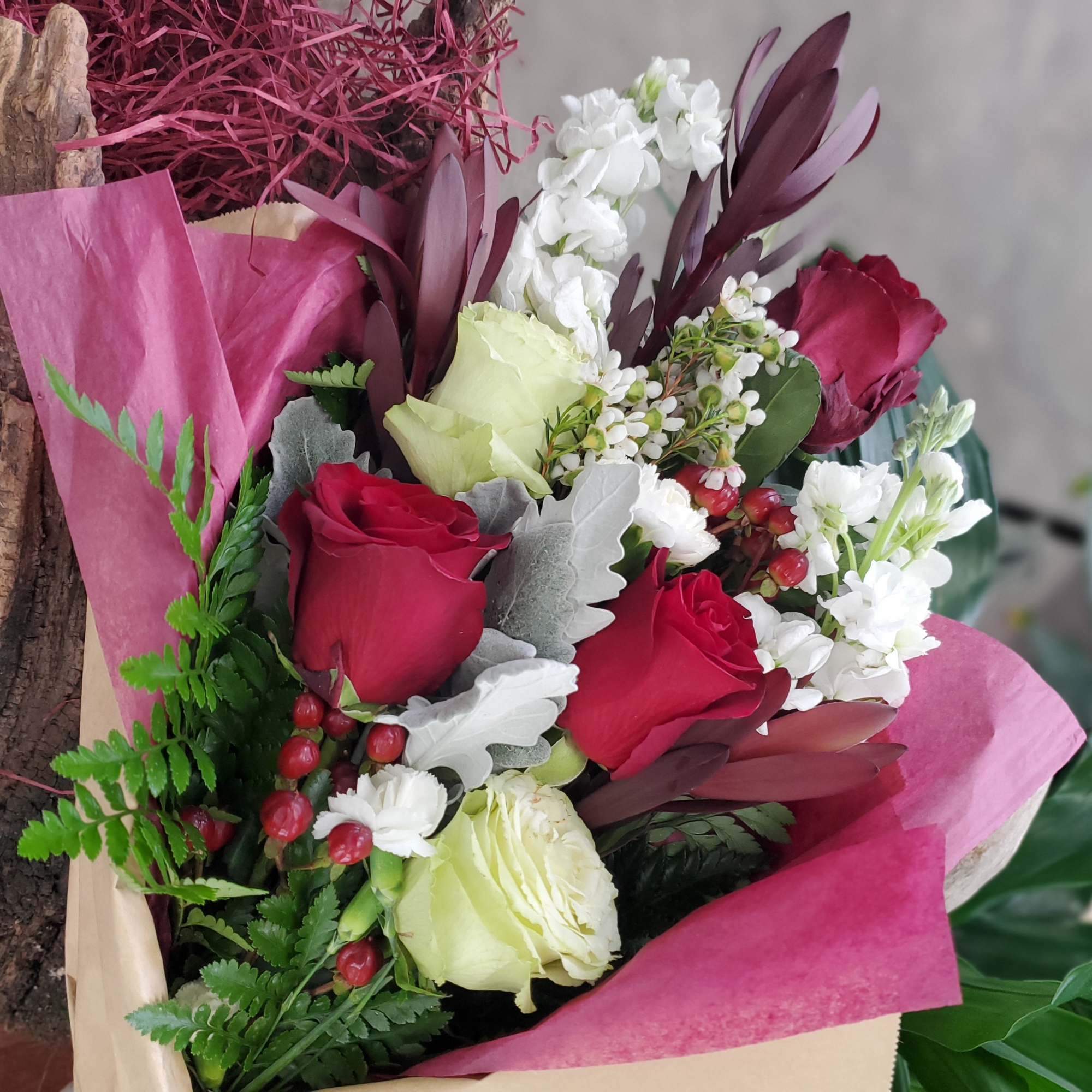 Bouquet of red and white roses with pink wrapping