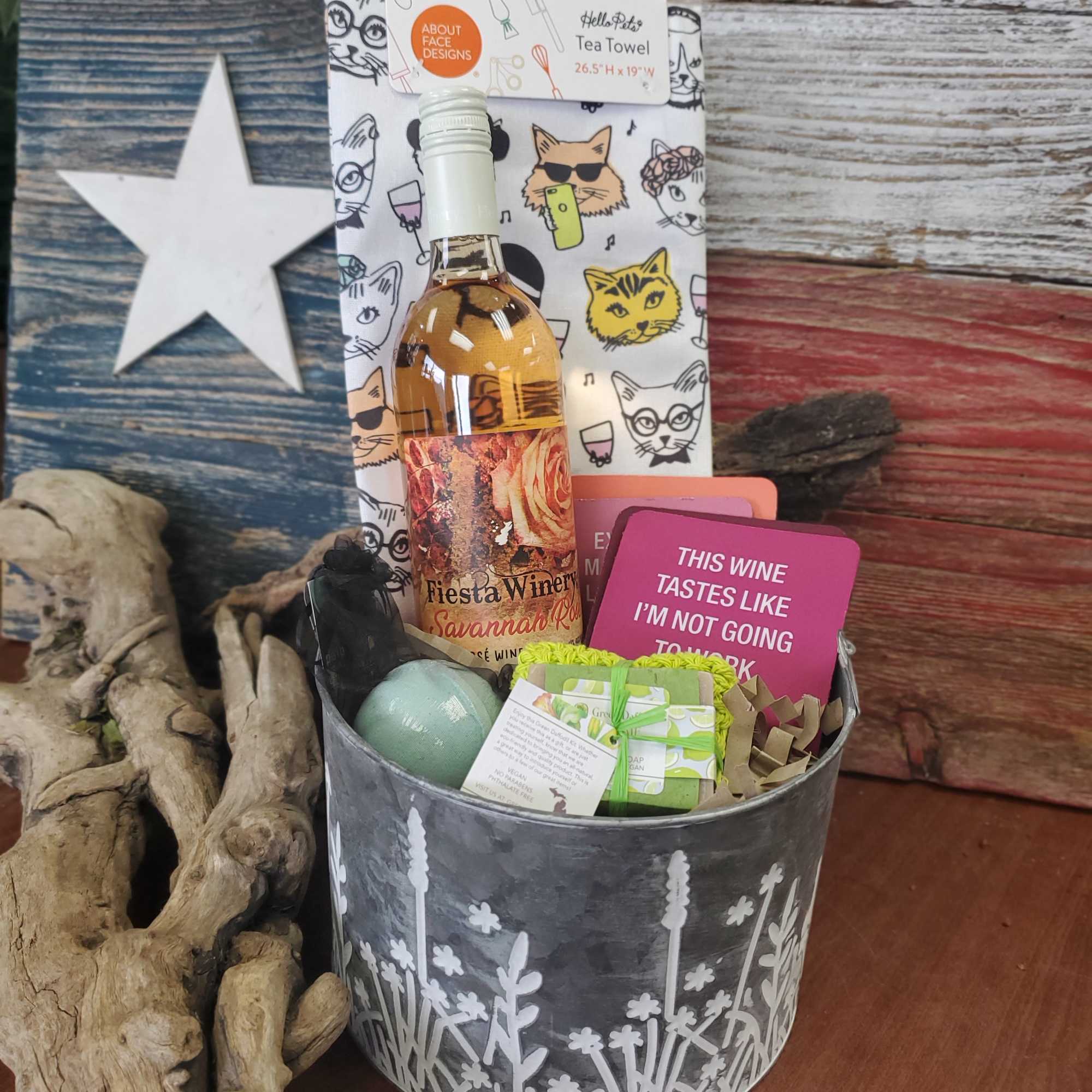 Gift basket with wine, tea towel, soap, bath items, and cards