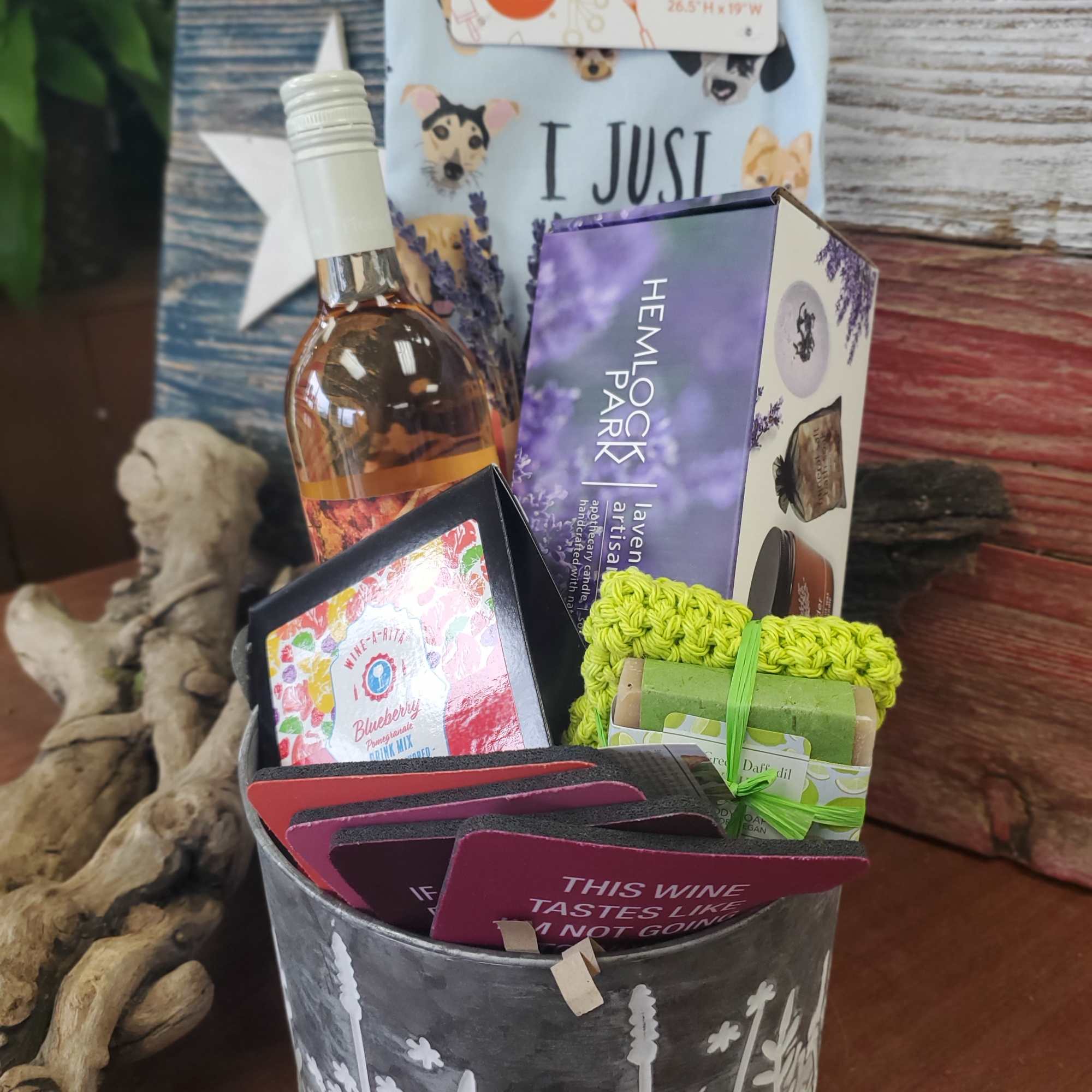 Gift basket with wine, candles, tea towel, and soap