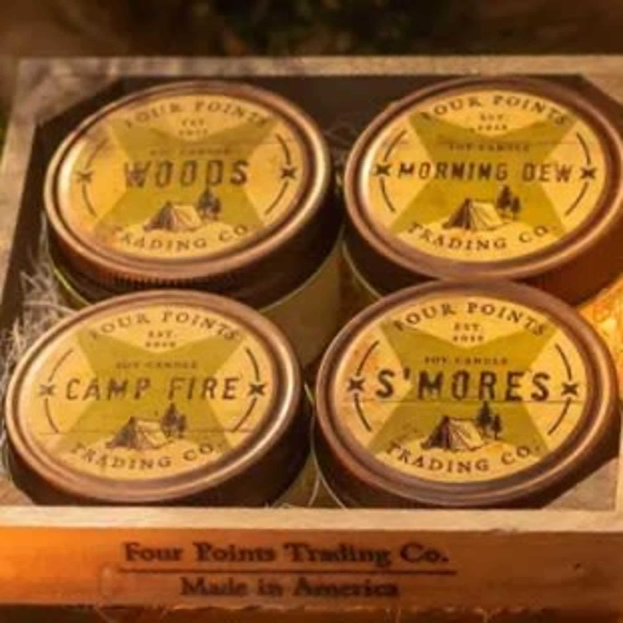 Four tins of scented wax melts in a wooden box
