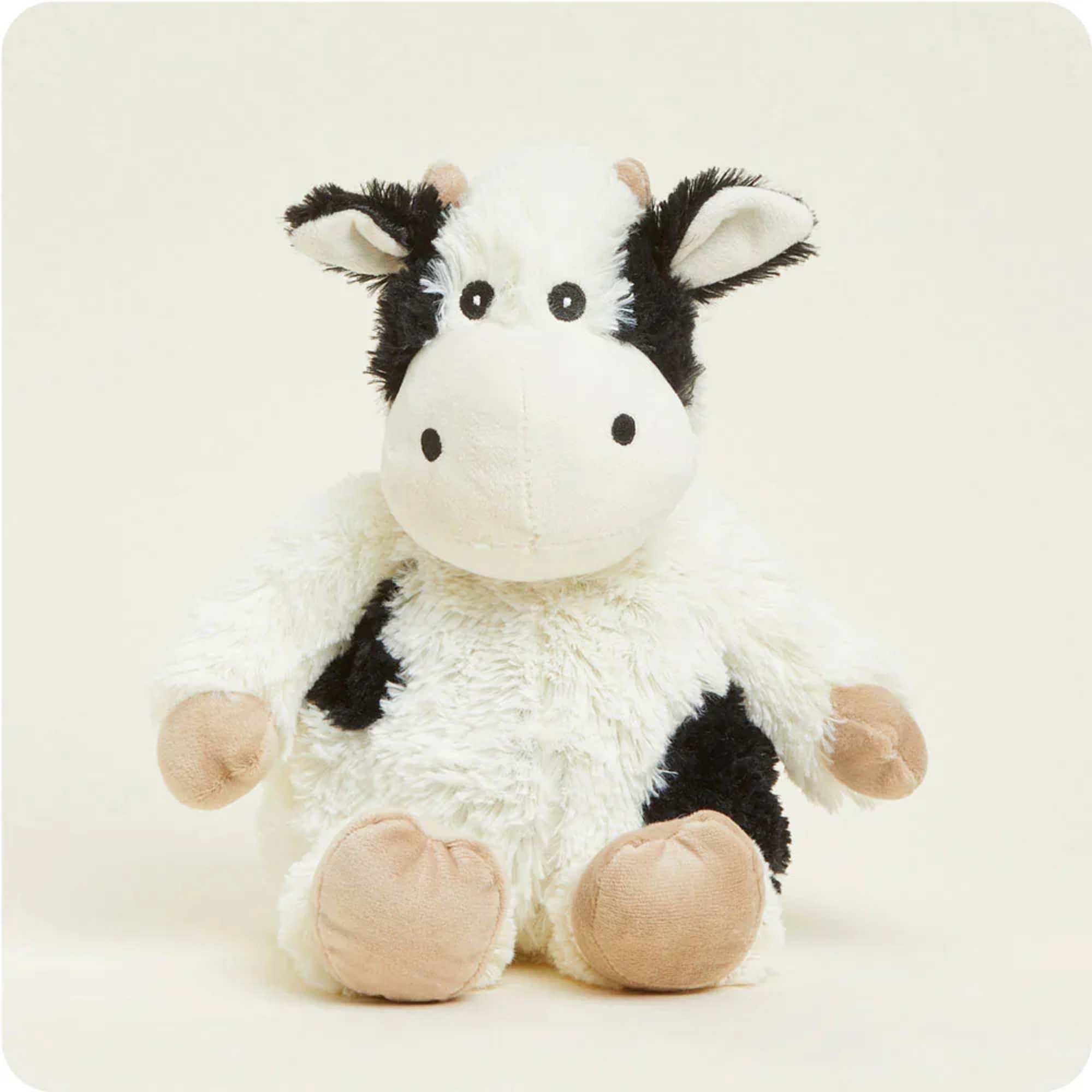 Plush black-and-white cow stuffed animal sitting upright