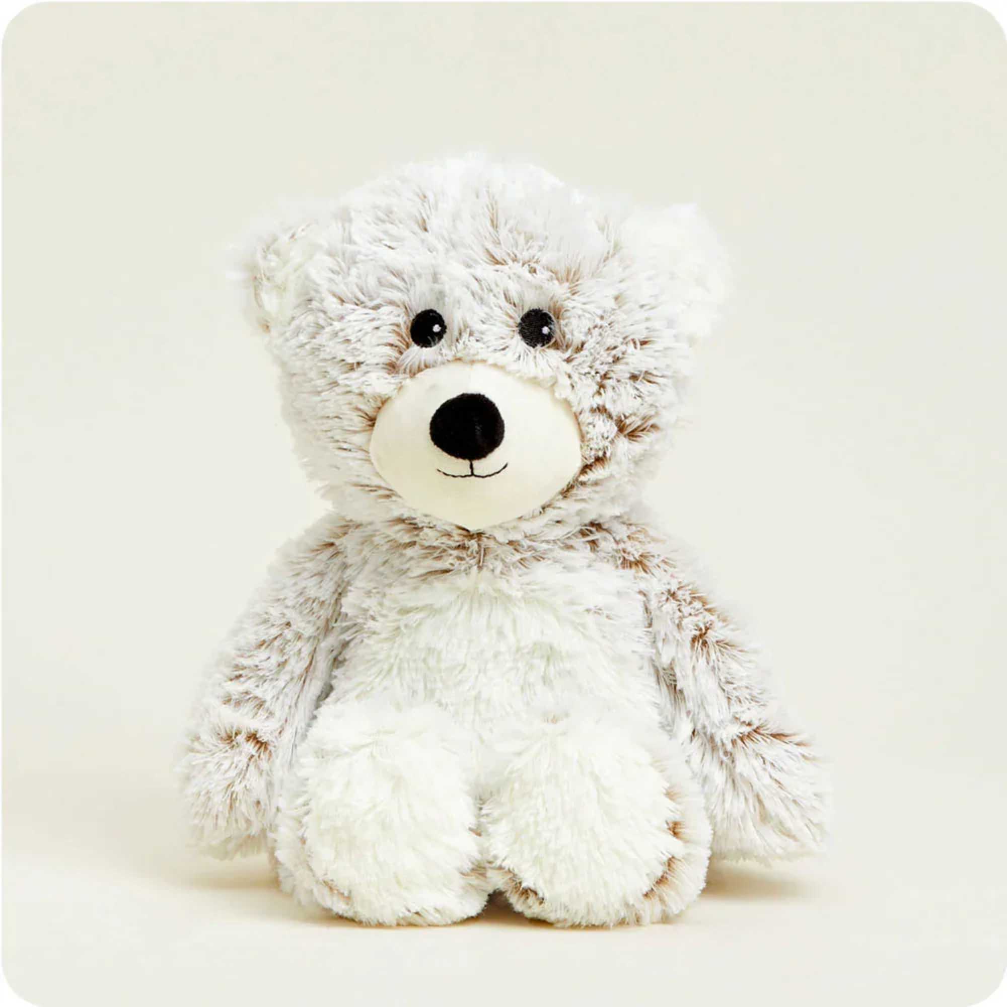 Plush teddy bear with white and tan fur sitting against a plain background