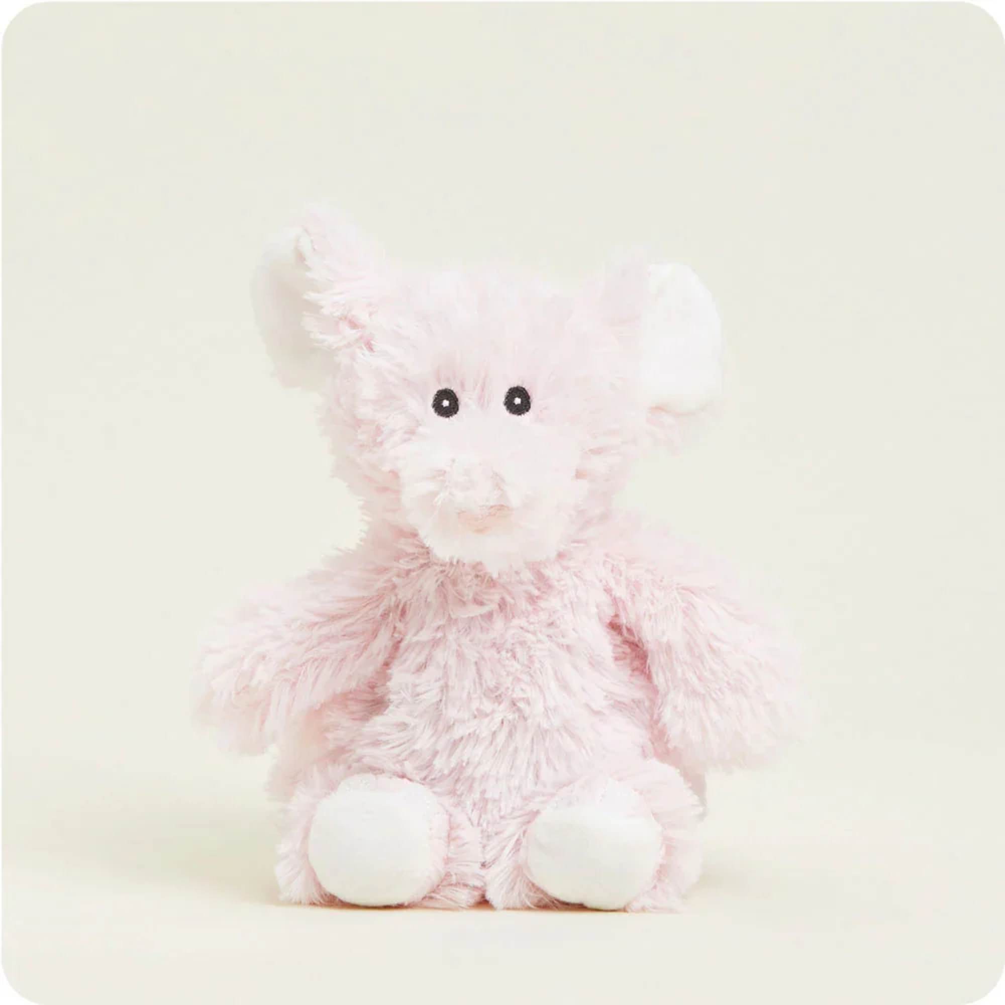 Pink plush teddy bear with white paws and black eyes