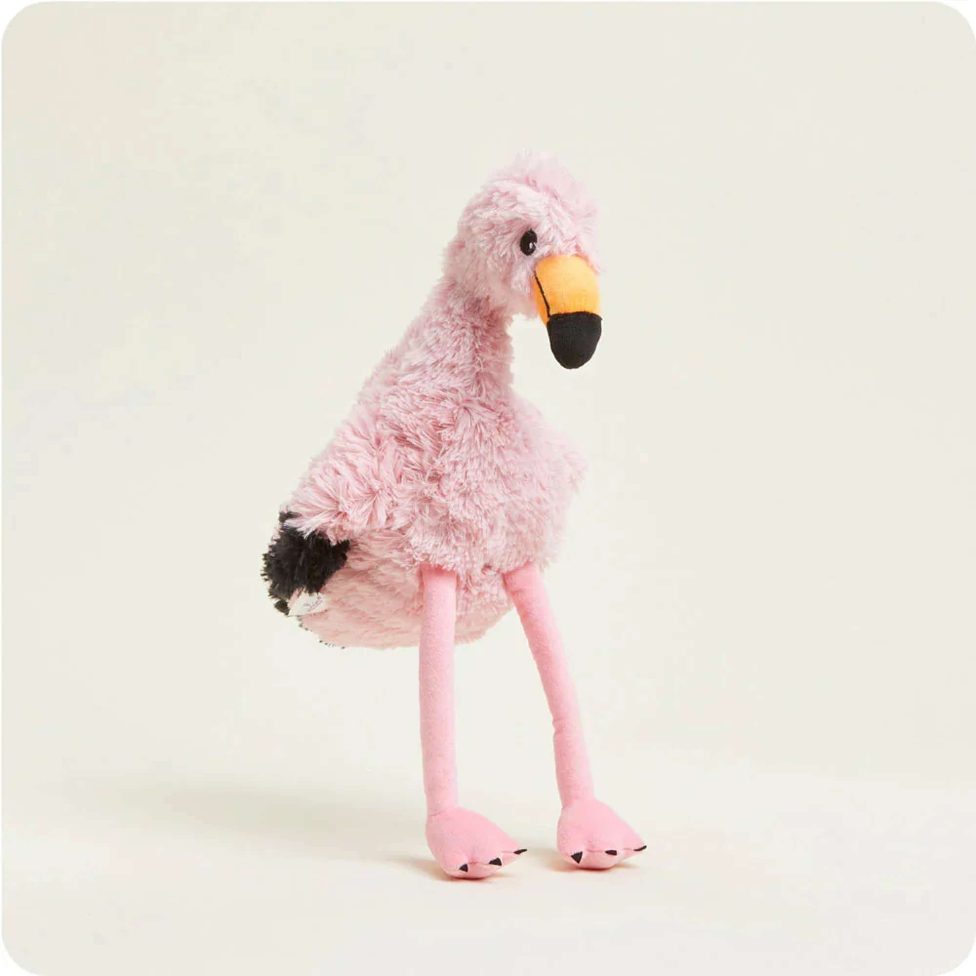 Pink plush flamingo toy with long legs on a plain background