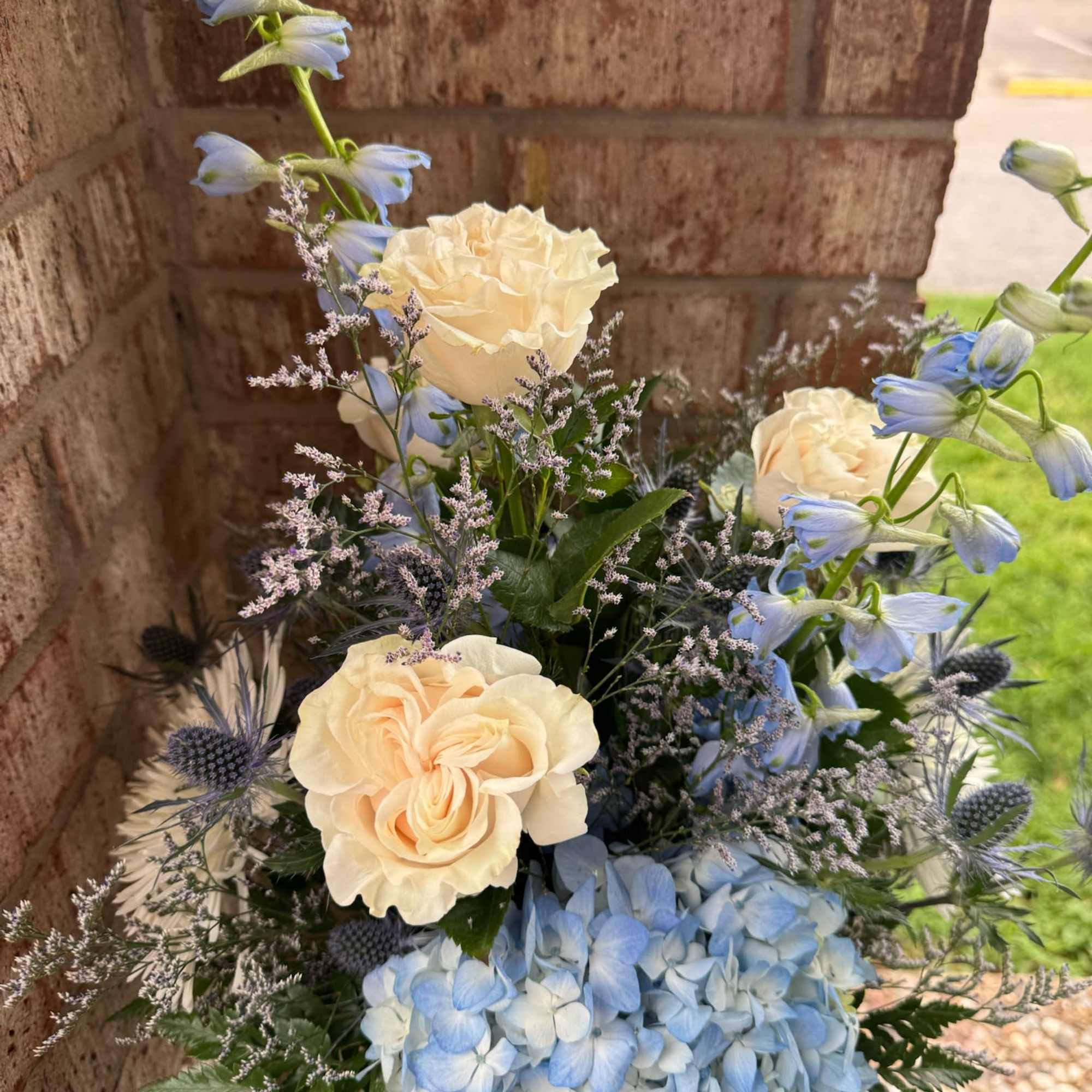 Blue hydrangeas and cream roses in a mixed bouquet