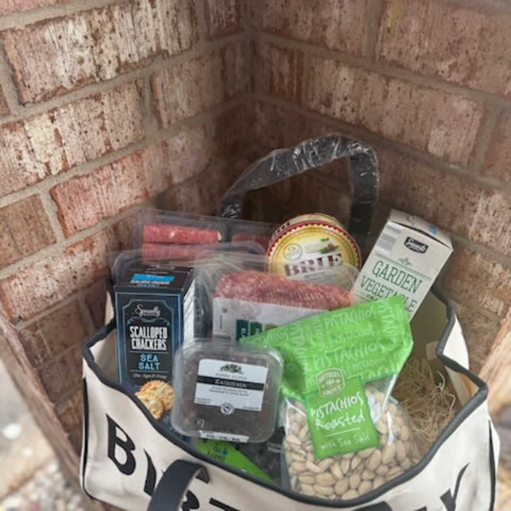 Gift bag filled with assorted snack packages and a birthday banner