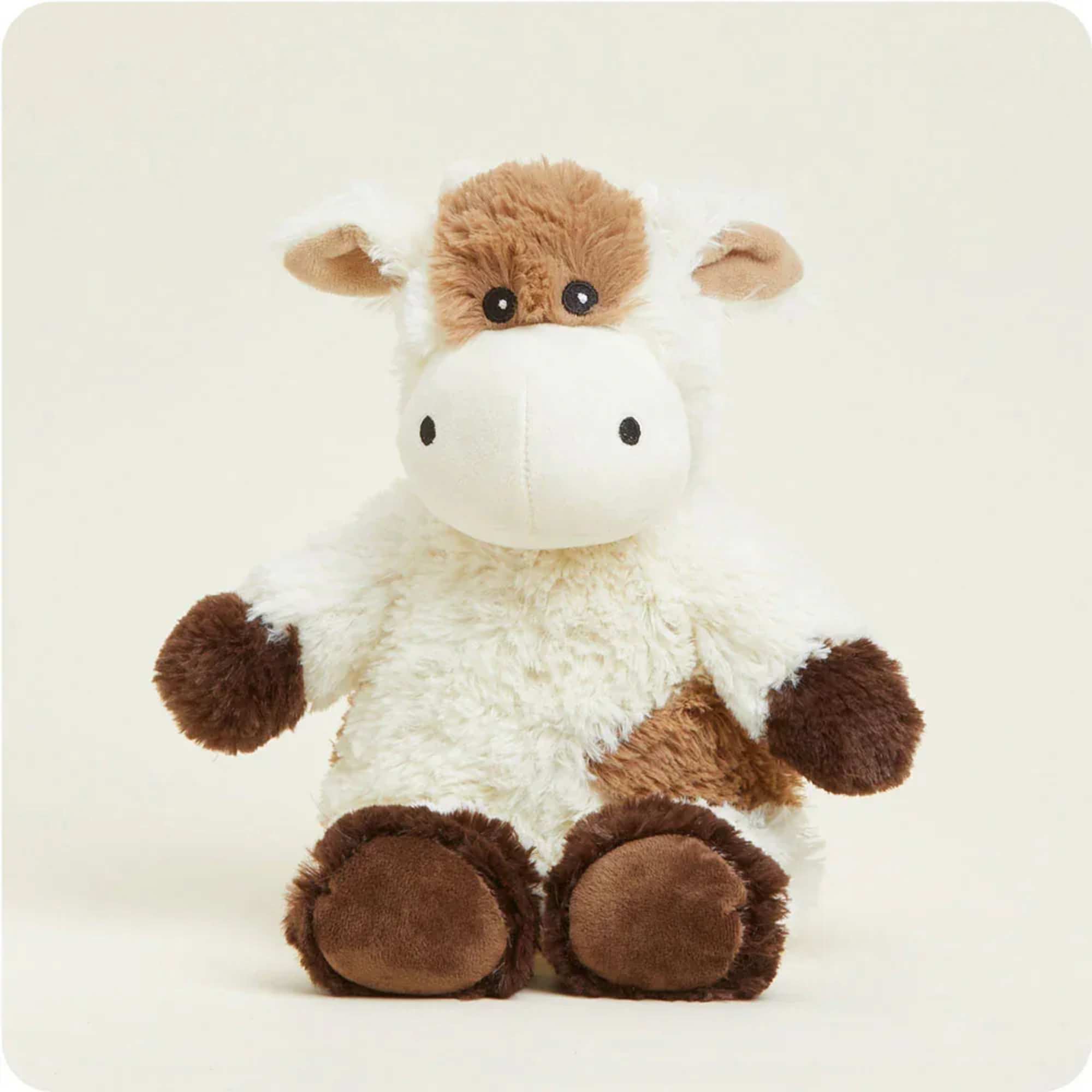 Plush cow stuffed animal with brown and white fur