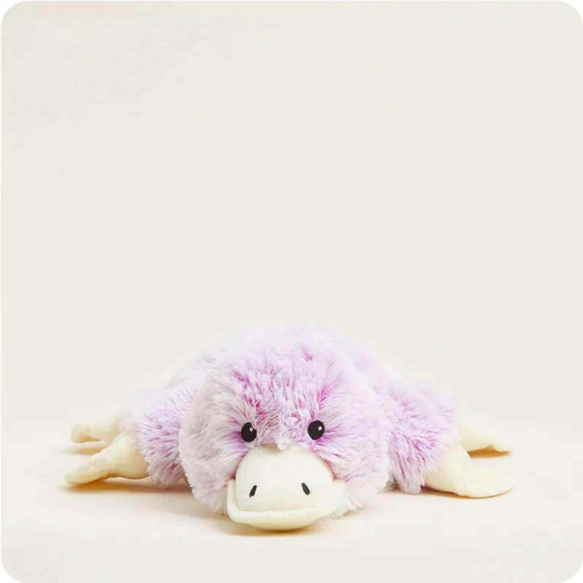 Plush pink-and-white stuffed animal lying flat on a light background