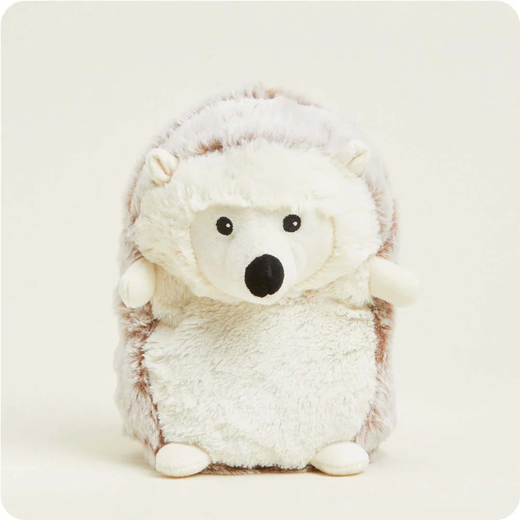 Plush hedgehog stuffed animal with a white face and brown fur