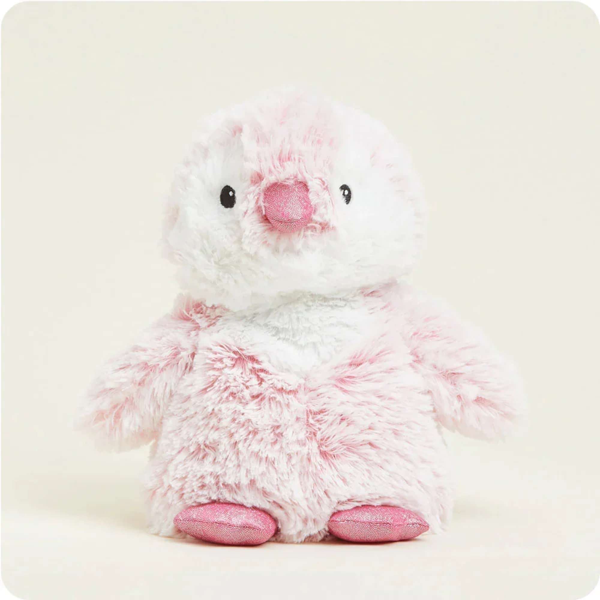 Small white and pink plush penguin toy on a plain background