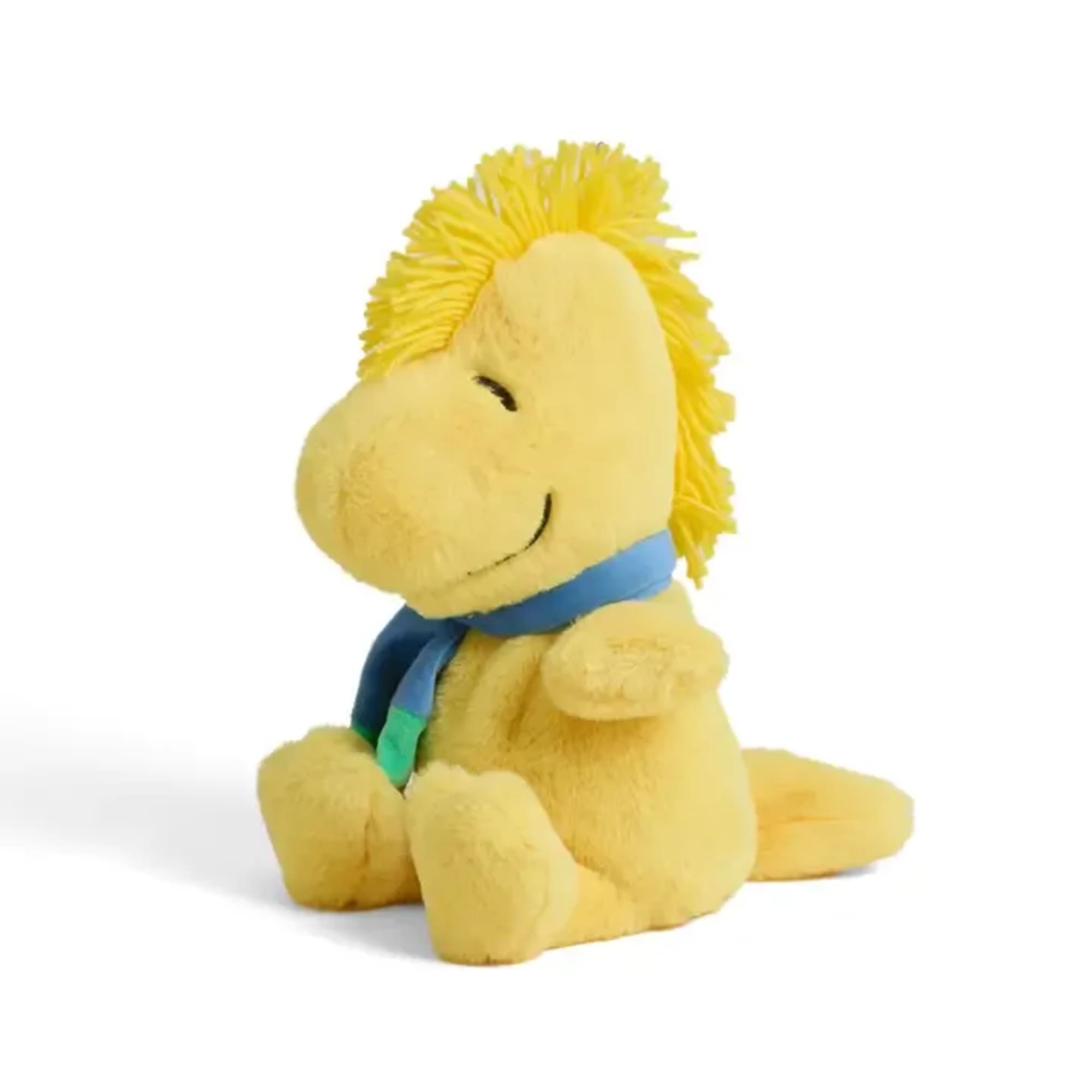 Yellow plush toy with a blue scarf sitting on a white background