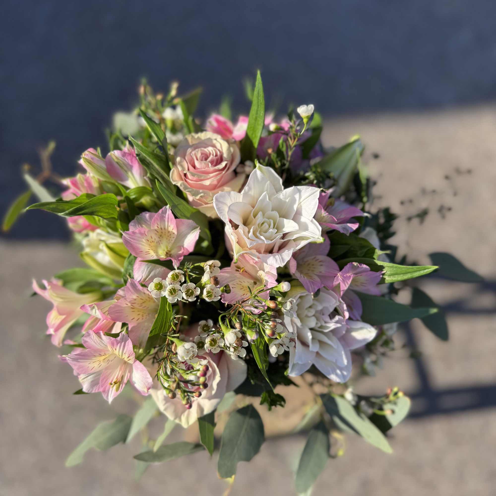 Hand-tied bouquet of pink and white flowers with greenery