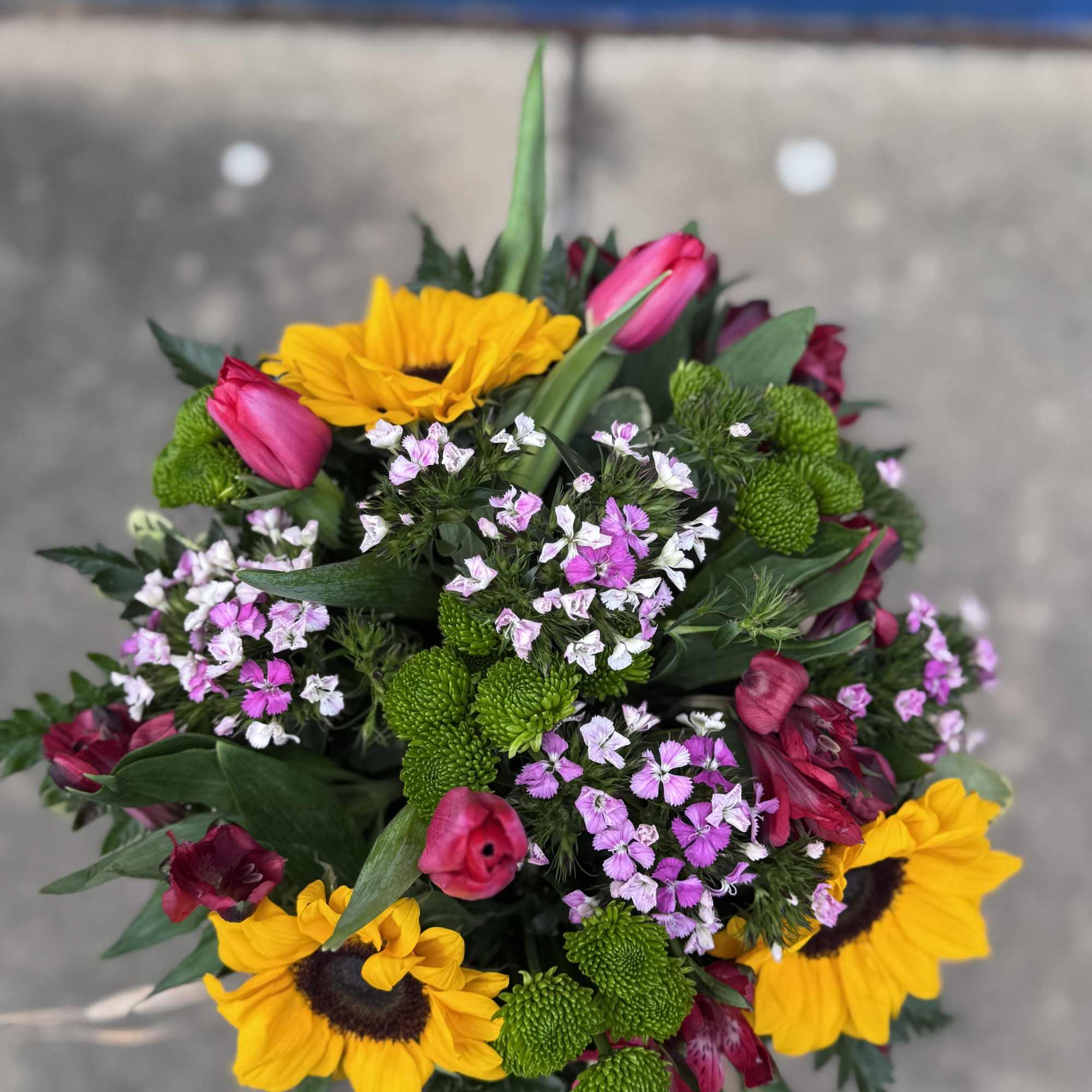 Bouquet with yellow sunflowers, pink tulips, and small pink-white filler flowers
