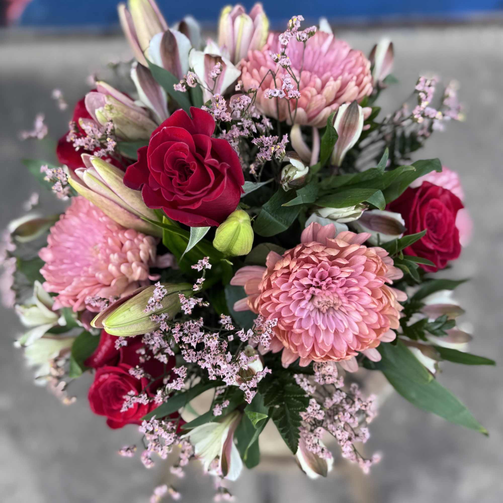 Bouquet of pink and red flowers with lilies and roses