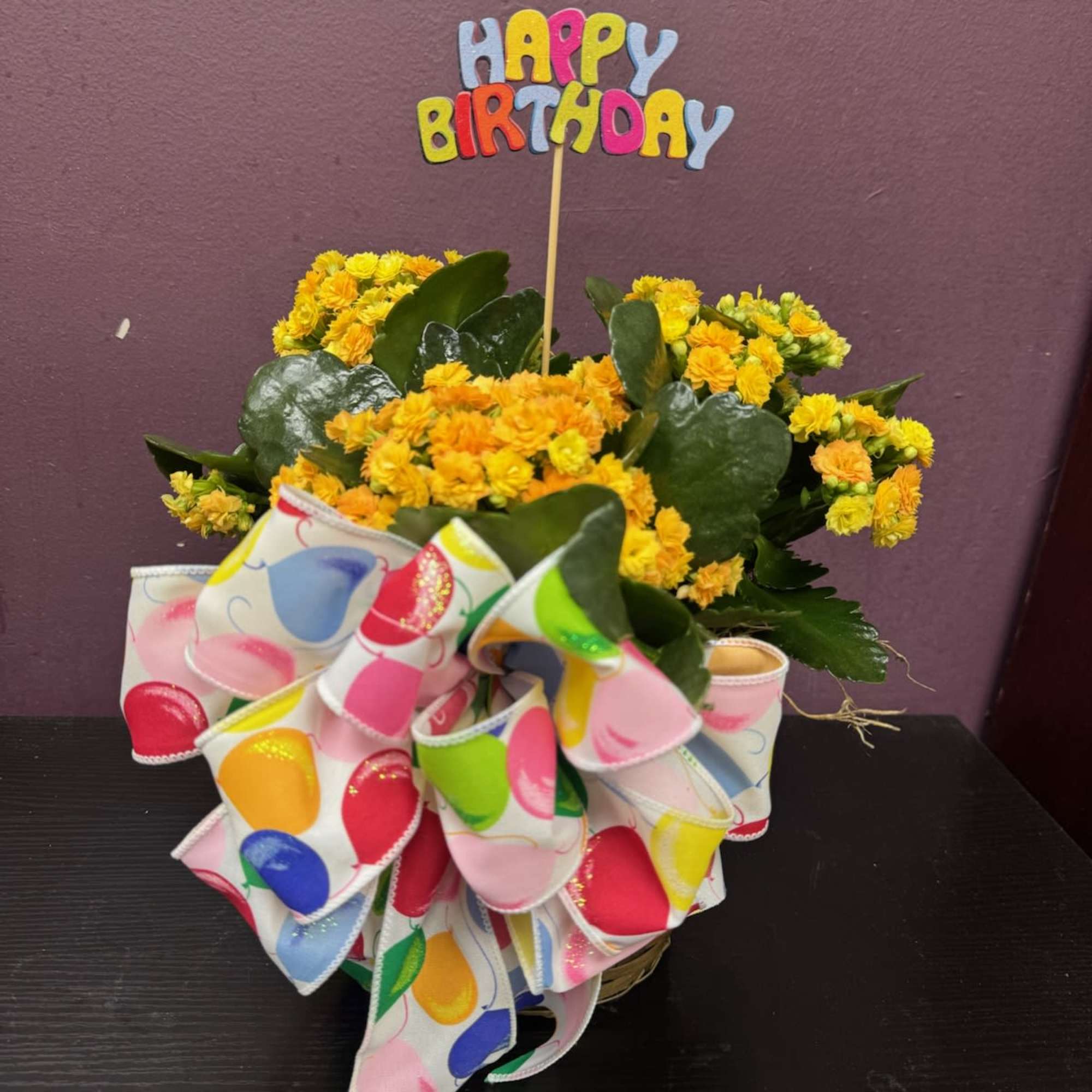 A beautiful blooming kalanchoe plant that is perfectly presented in a basket