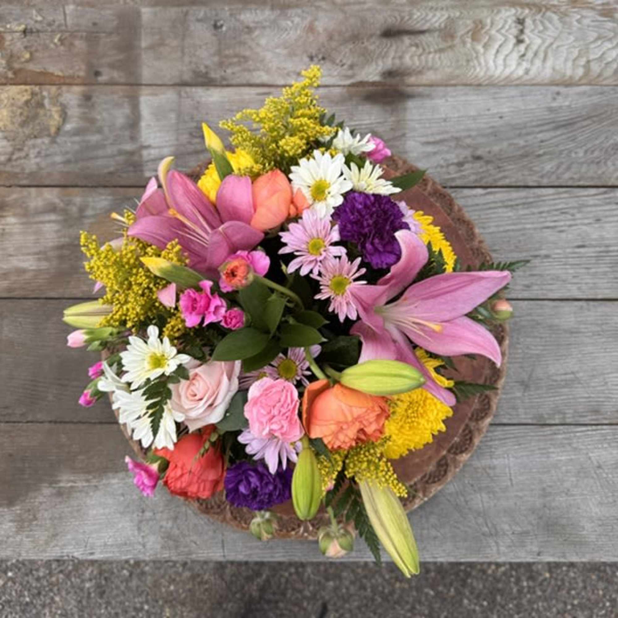 Mixed bouquet of pink, white, yellow, and purple flowers