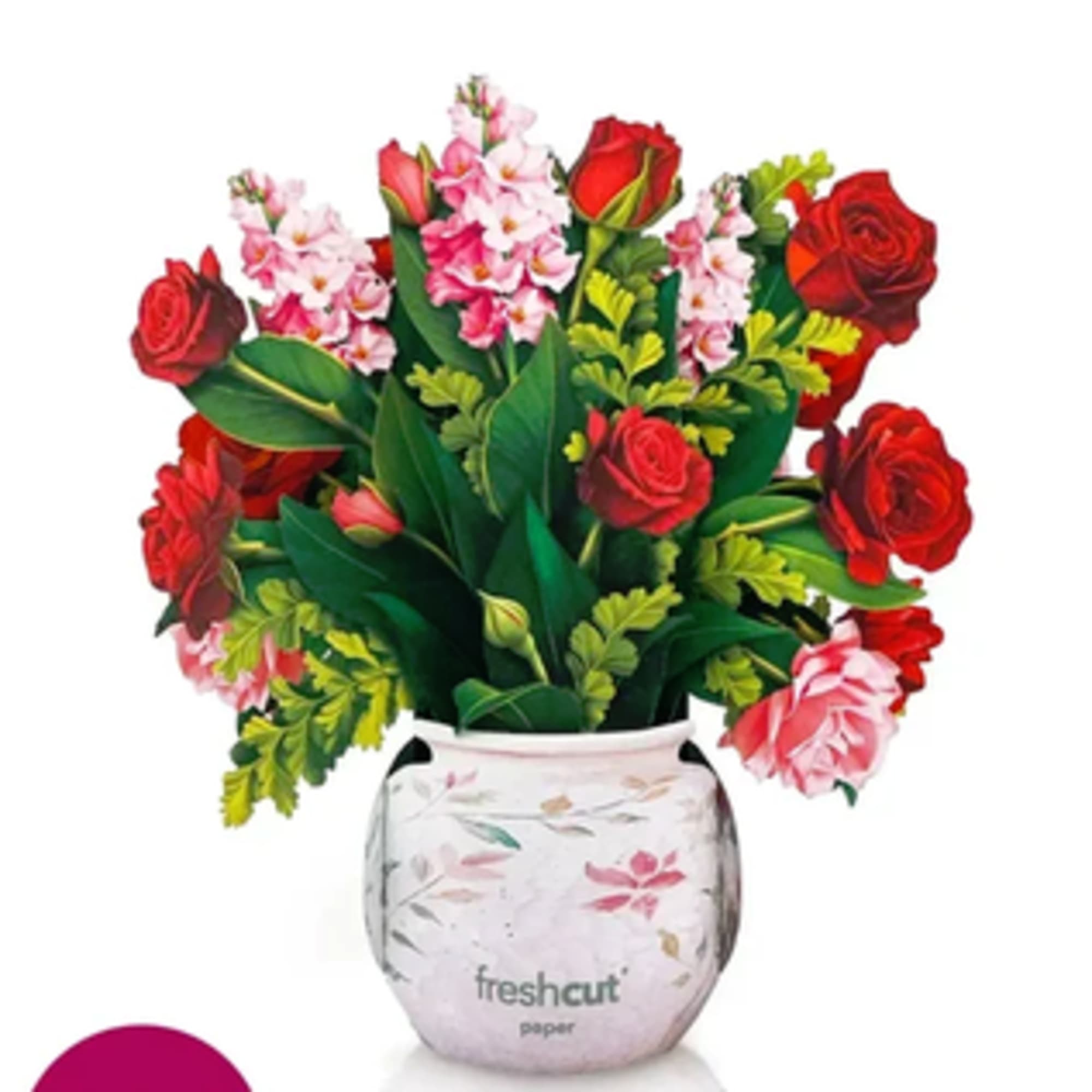 Bouquet of red roses and pink flowers in a white floral vase