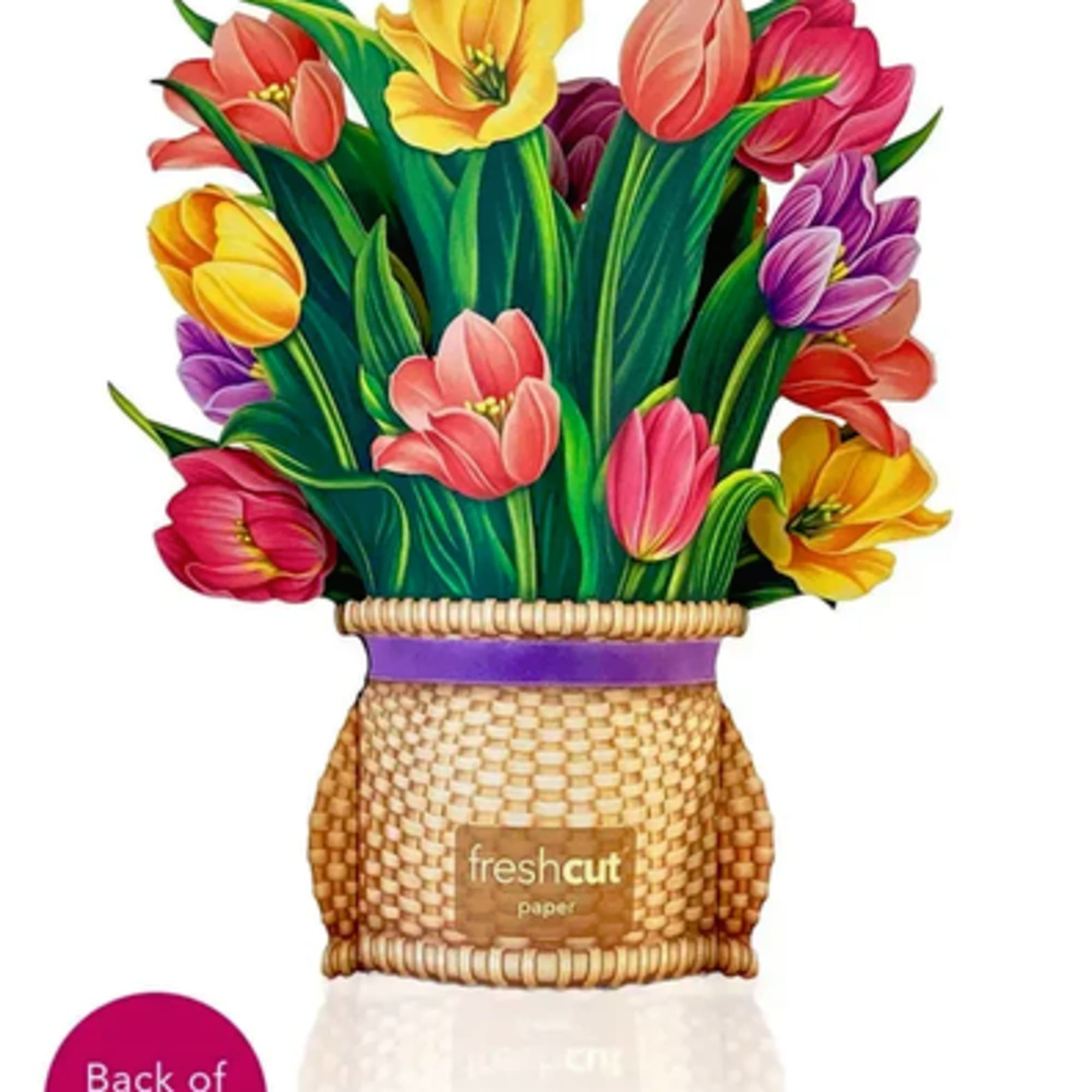 Colorful tulips arranged in a woven basket with a purple ribbon