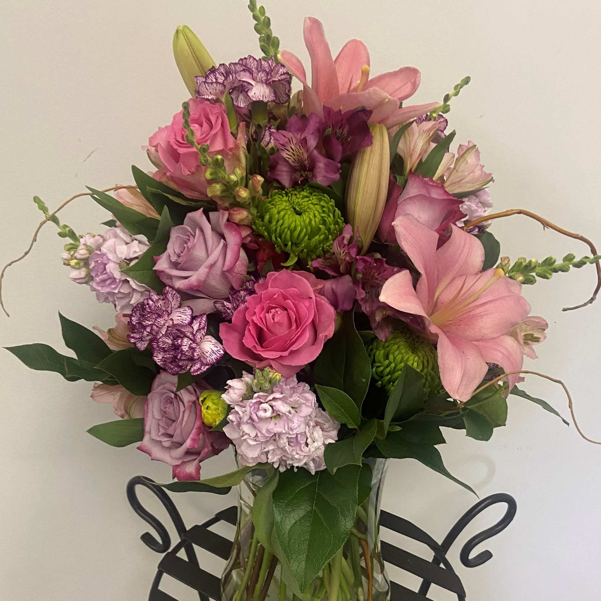 Pink and purple mixed bouquet in a clear glass vase