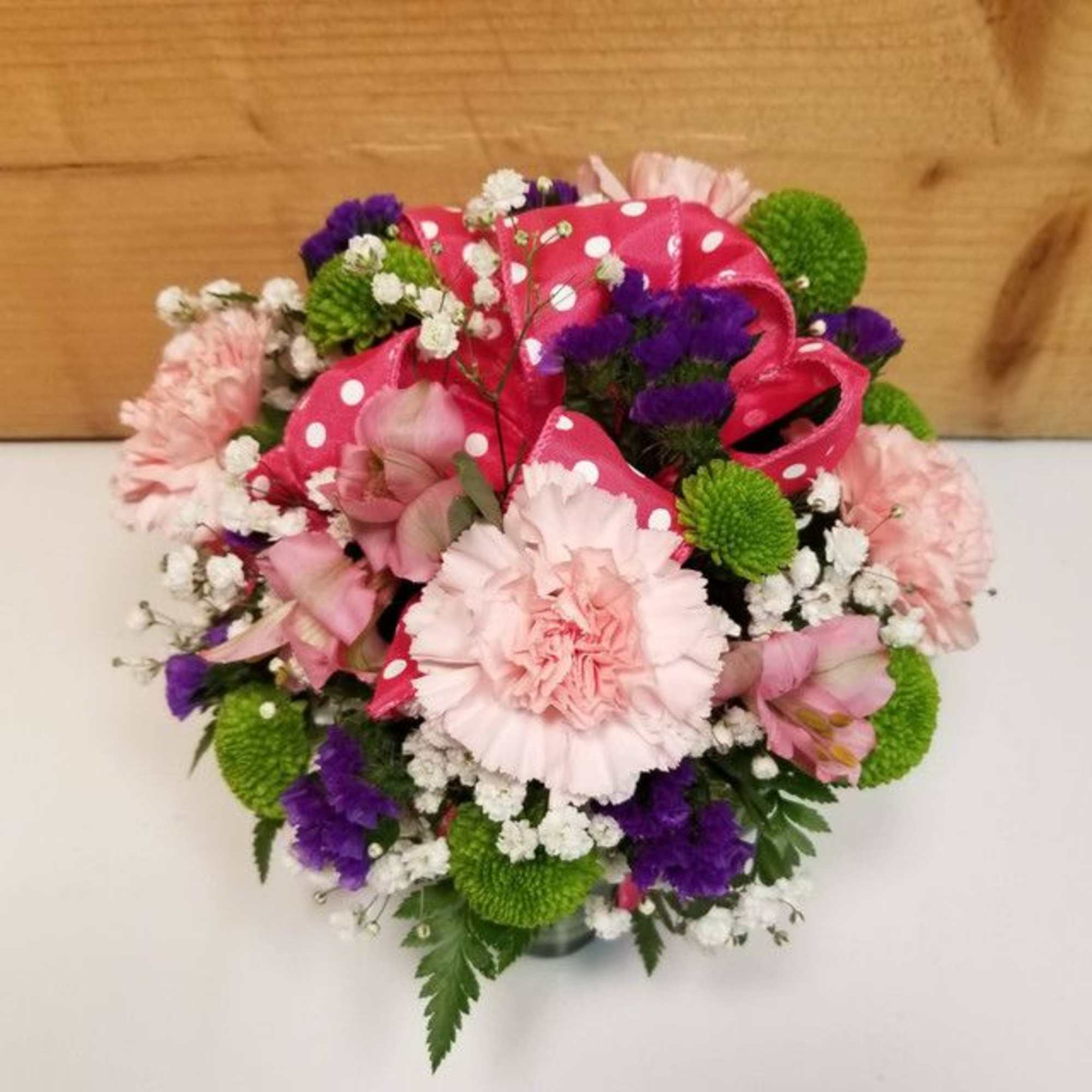 Pink and purple bouquet with green button mums and a polka-dot ribbon