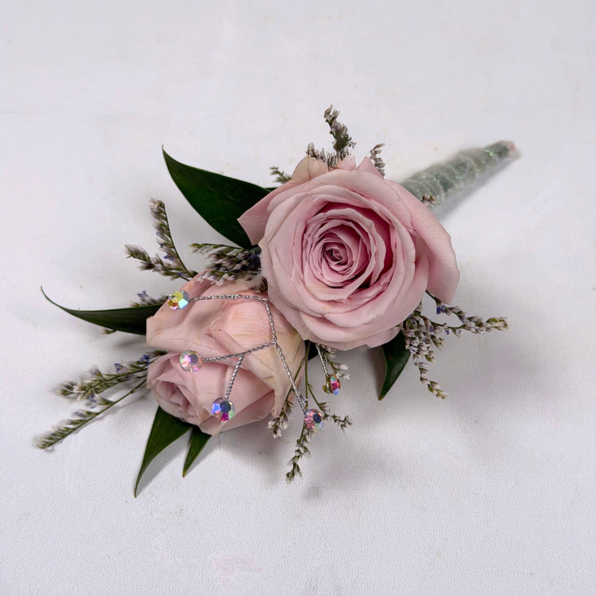 Soft pale lavender roses take center stage in this Amethyst boutonniere, a