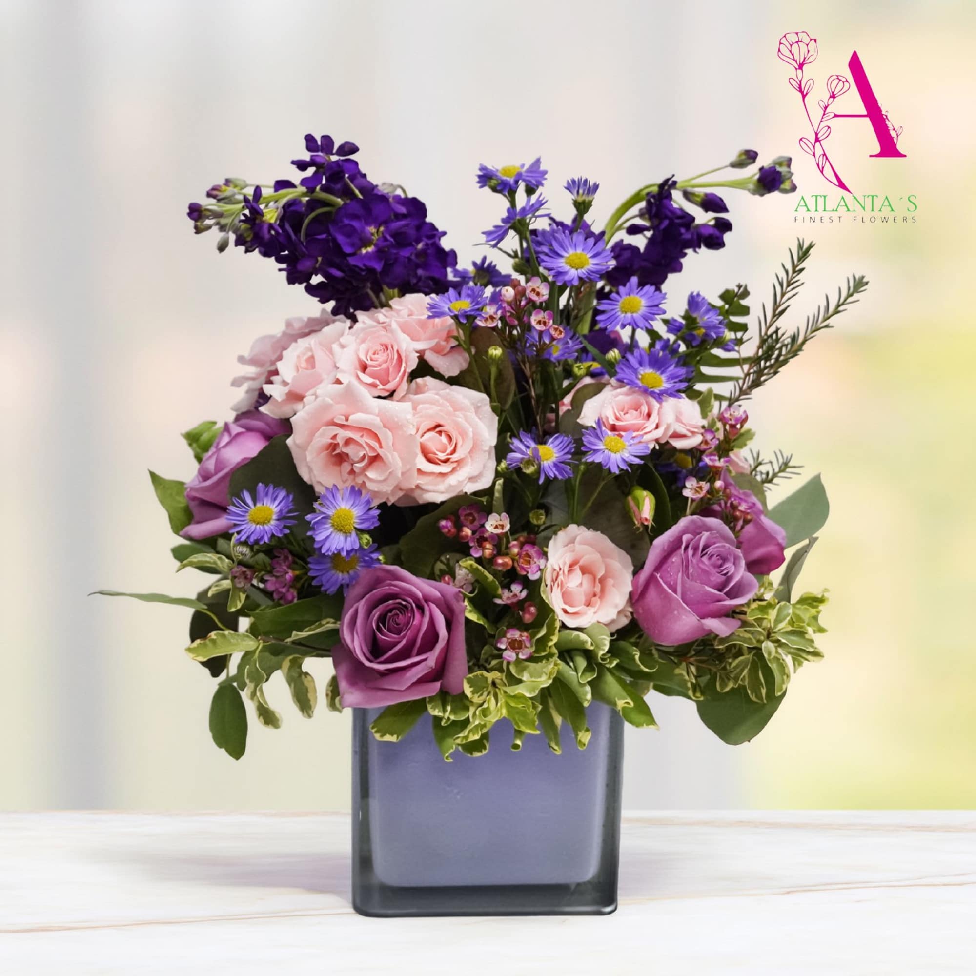 A lush mix of large white roses, blush pink spray roses, and, photo 2 of 2
