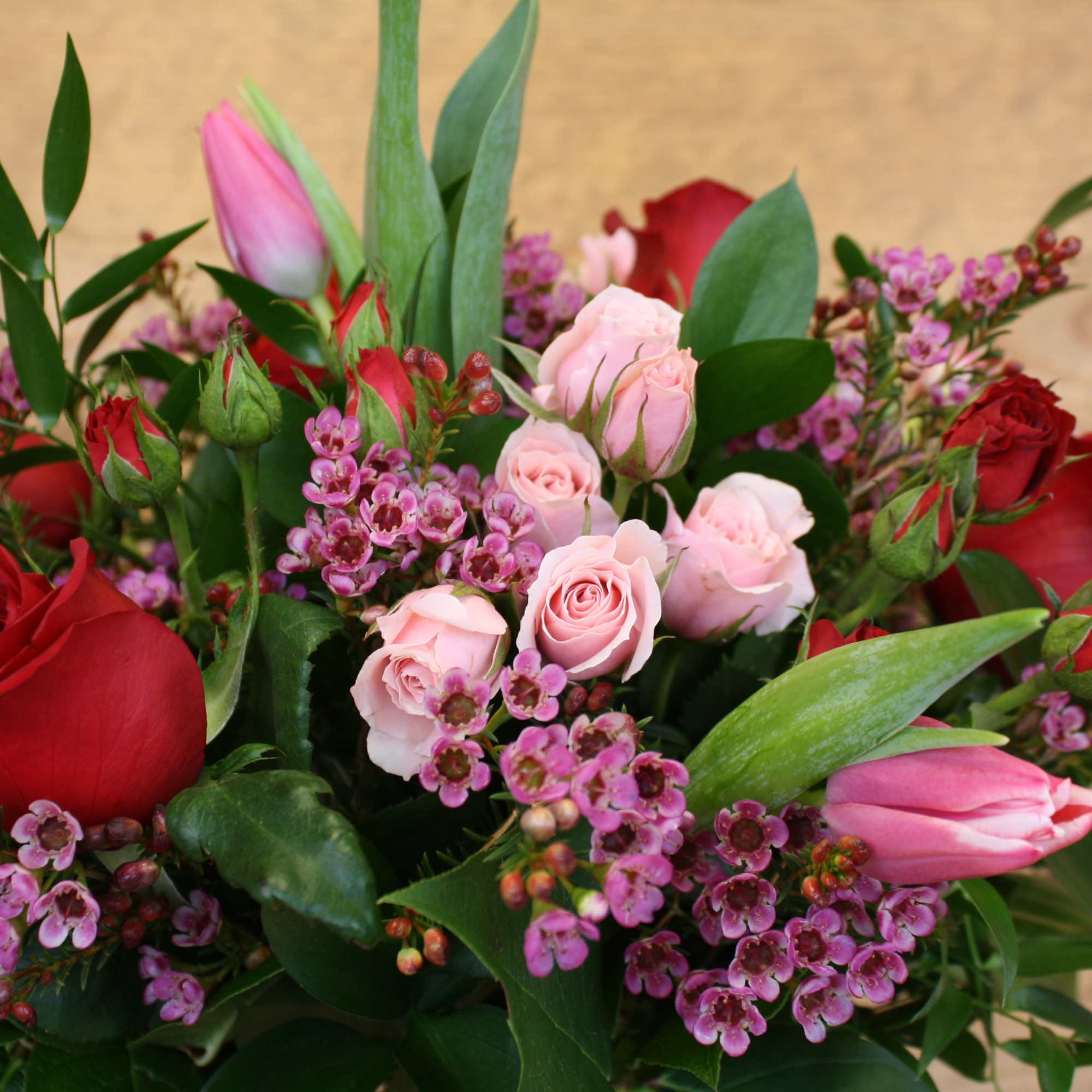 Elegant vase filled with mixed seasonal blooms.  