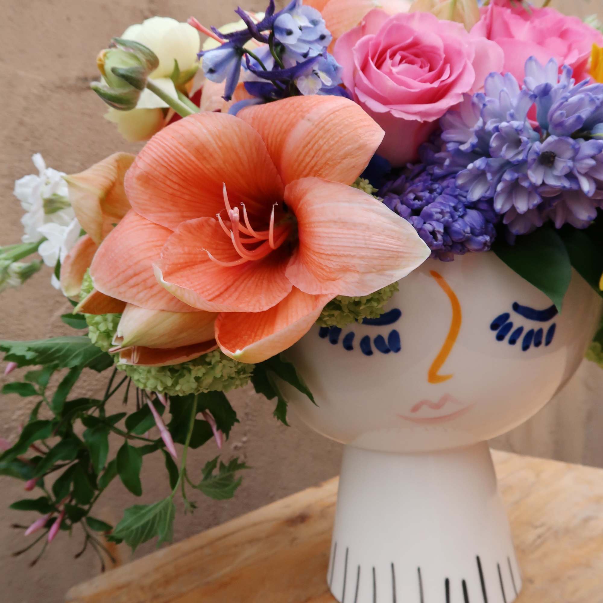 Lola face vase filled with the seasons blooms, bright and beautiful., photo 5 of 5