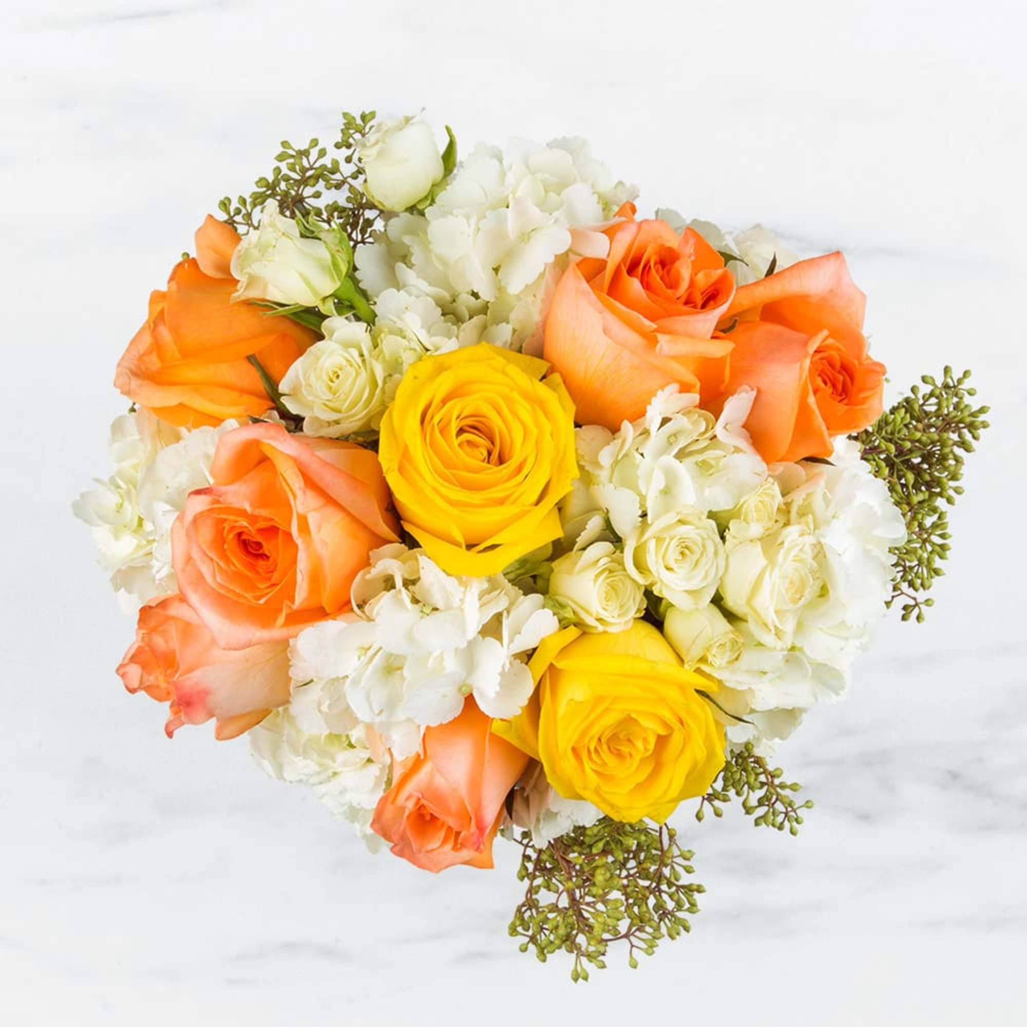 Bouquet of orange and yellow roses with white filler flowers