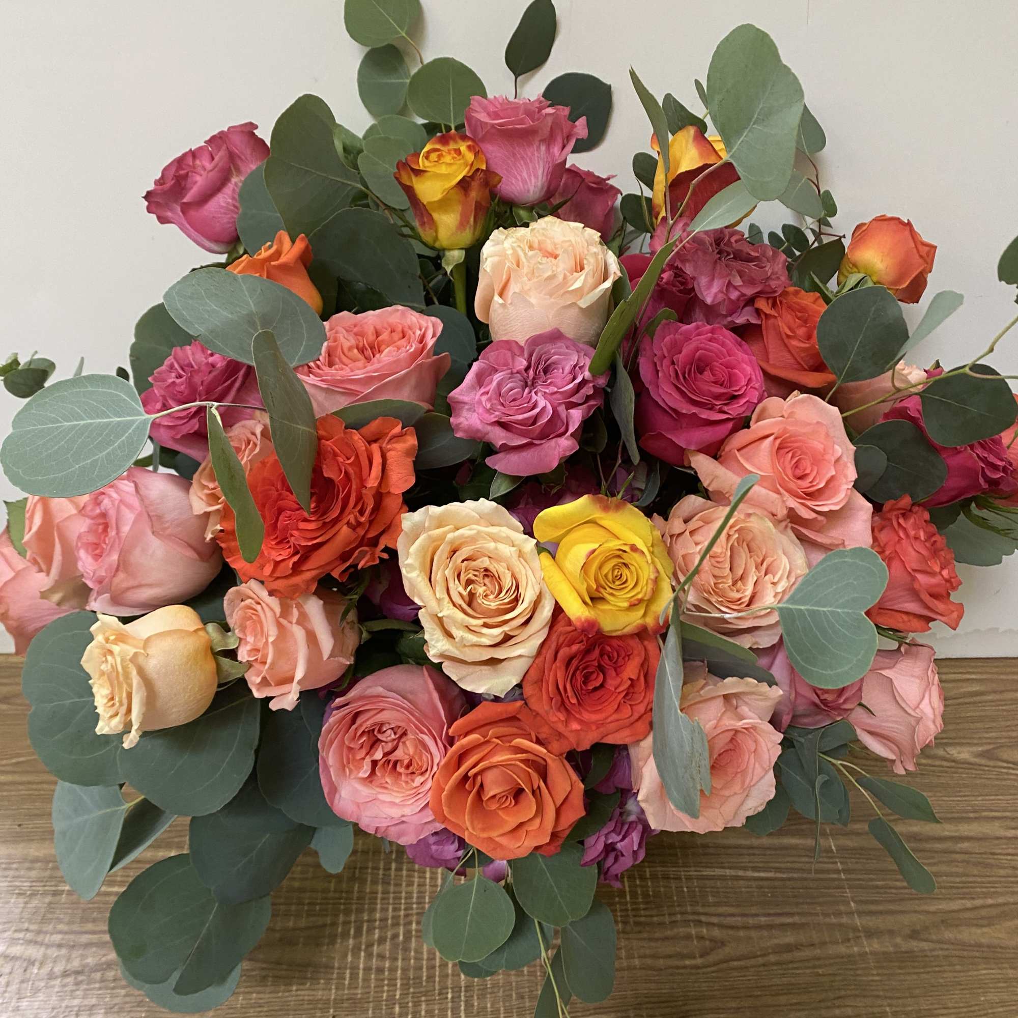 Combination of different colors of flowers in a gold vase