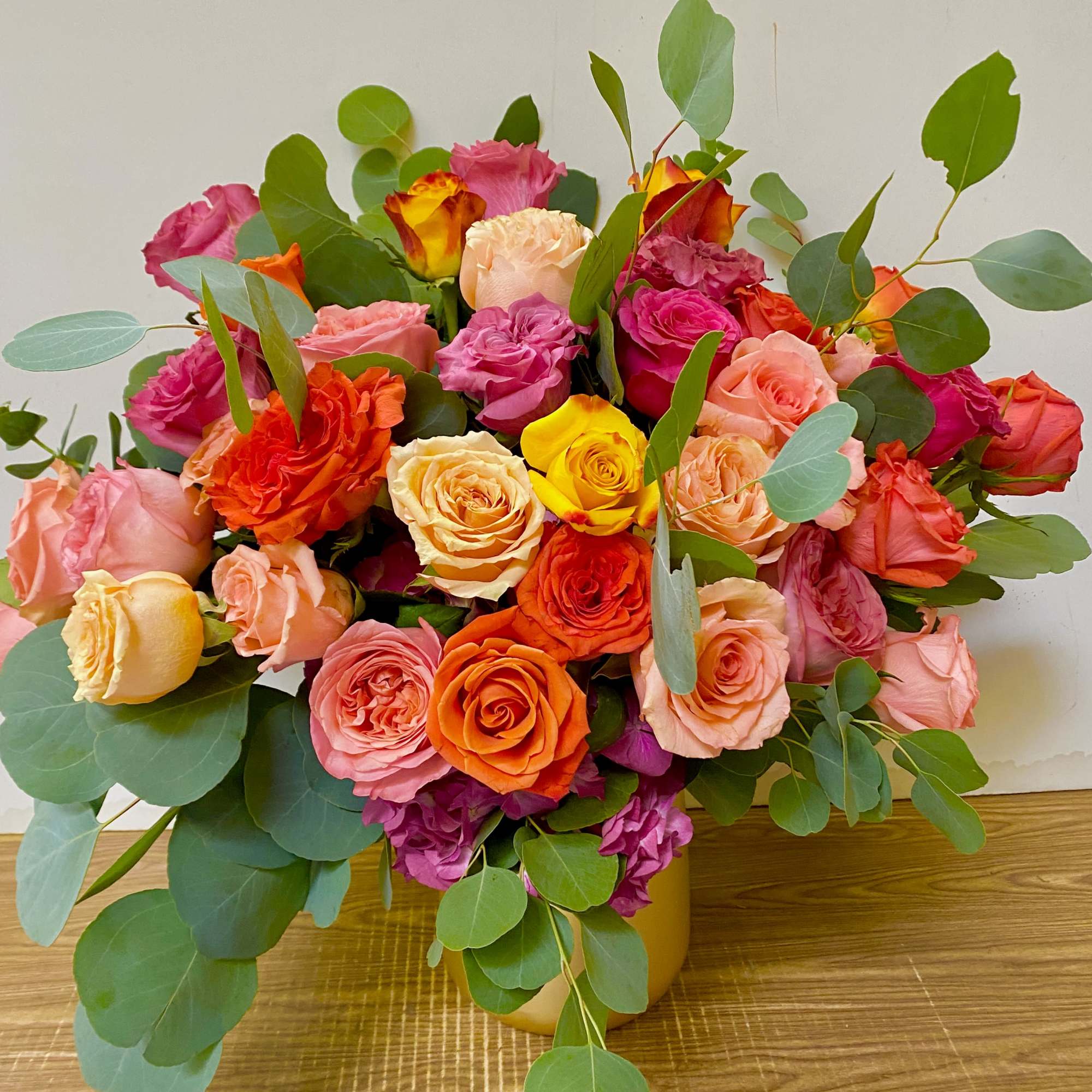 Combination of different colors of flowers in a gold vase
