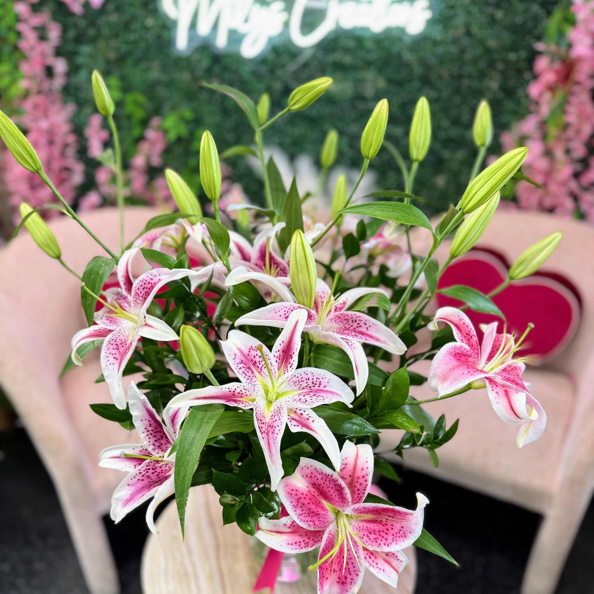Pink and white lilies arranged in a bouquet with unopened buds