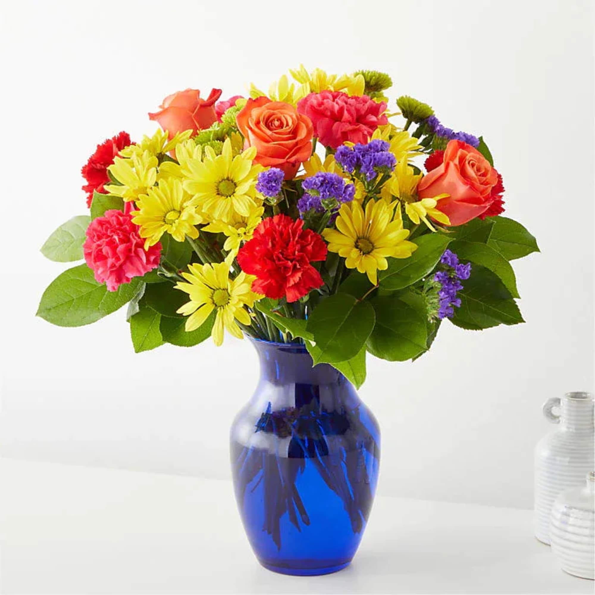 Bright, cheerful, and full of personality, this lush rounded arrangement features sunny